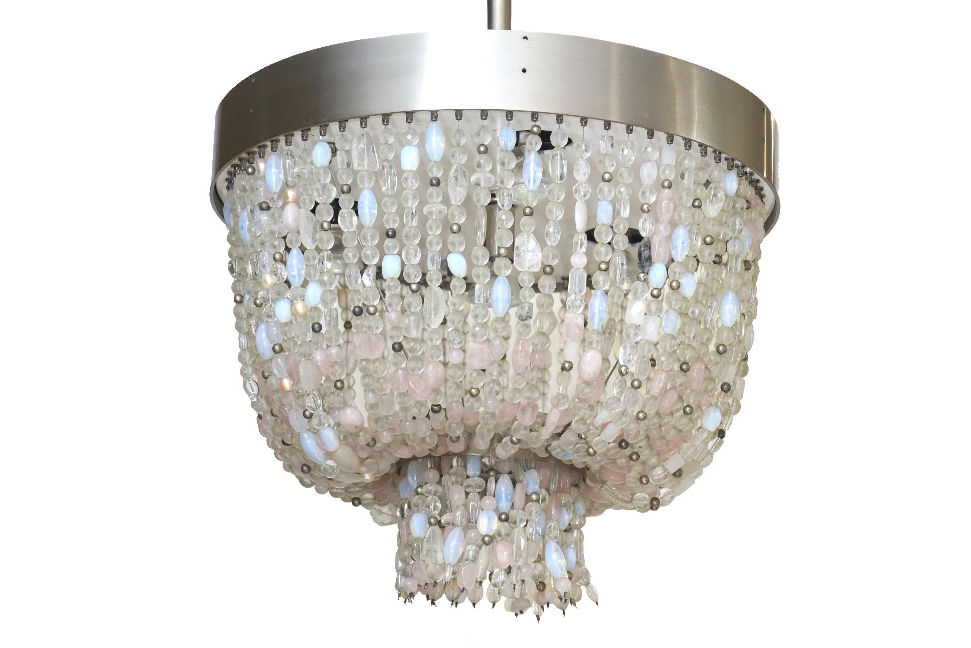 This lovely 2 tier chandelier by Thomas Fuchs for the Kentfield Collection in 2007 is called the Lavaliere. It is comprised of hanging beads of rose quartz, quartz and interspersed czech beads with silver filaments. The colors are pale blue to pale