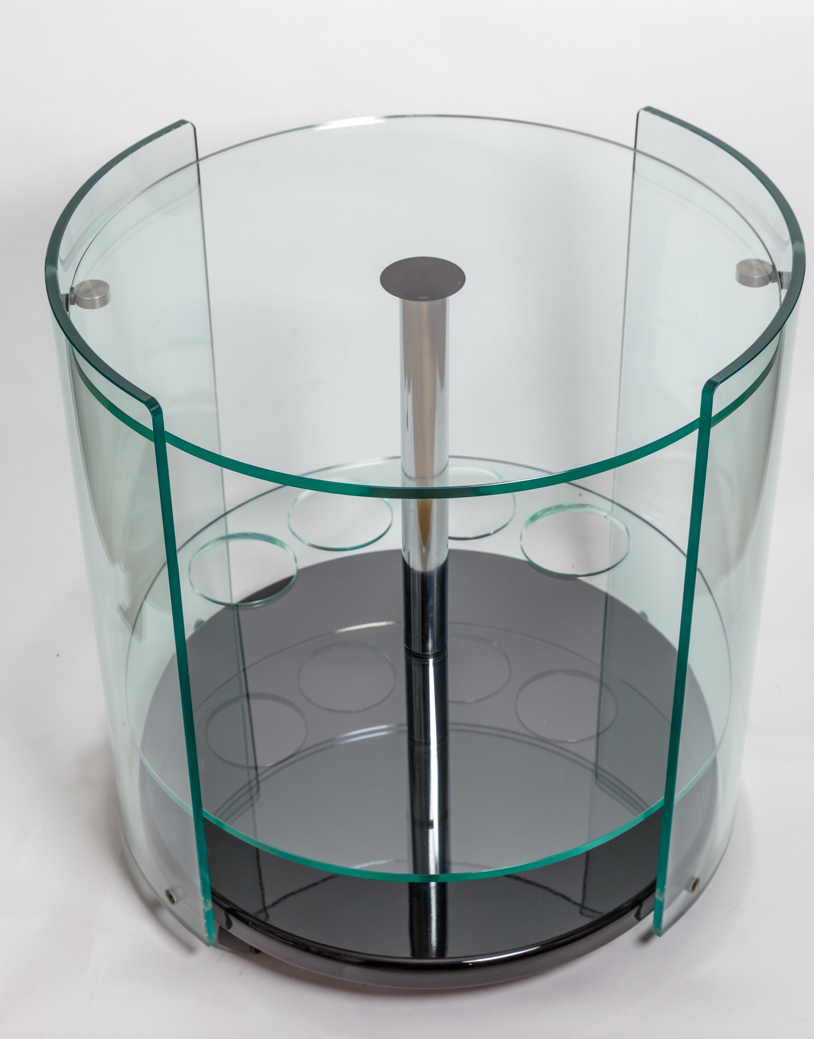 Two tier rolling round glass bar cart with black base and chrome detail.