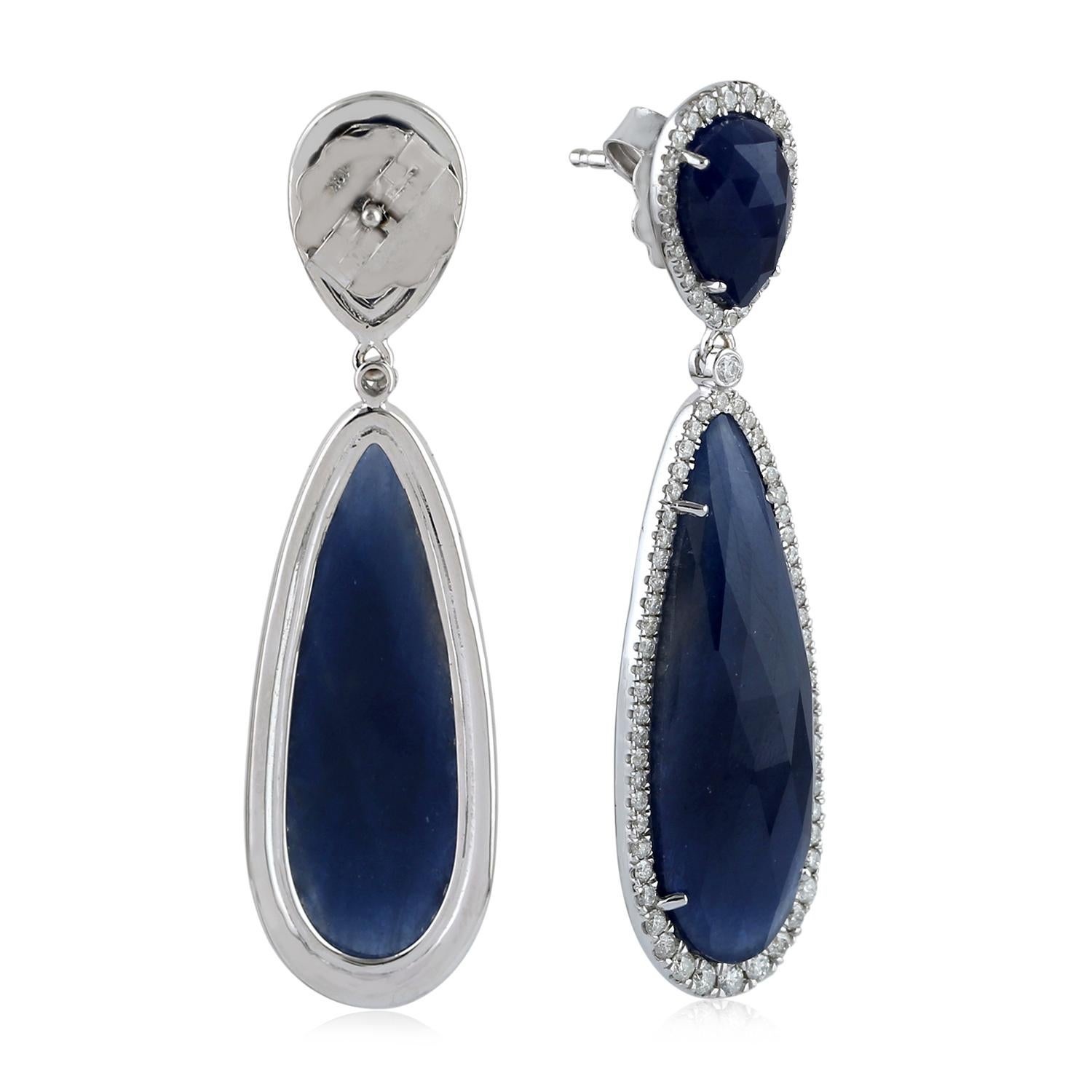 Two-Tier Pear and round shape Slice Sapphire and Diamond Dangle Drop Earring in 18k White Gold, perfect for any occasion.

Closure: Push Post

18KT Gold:8.046gms
Diamond:1.23cts
Sapphire:29.39cts
