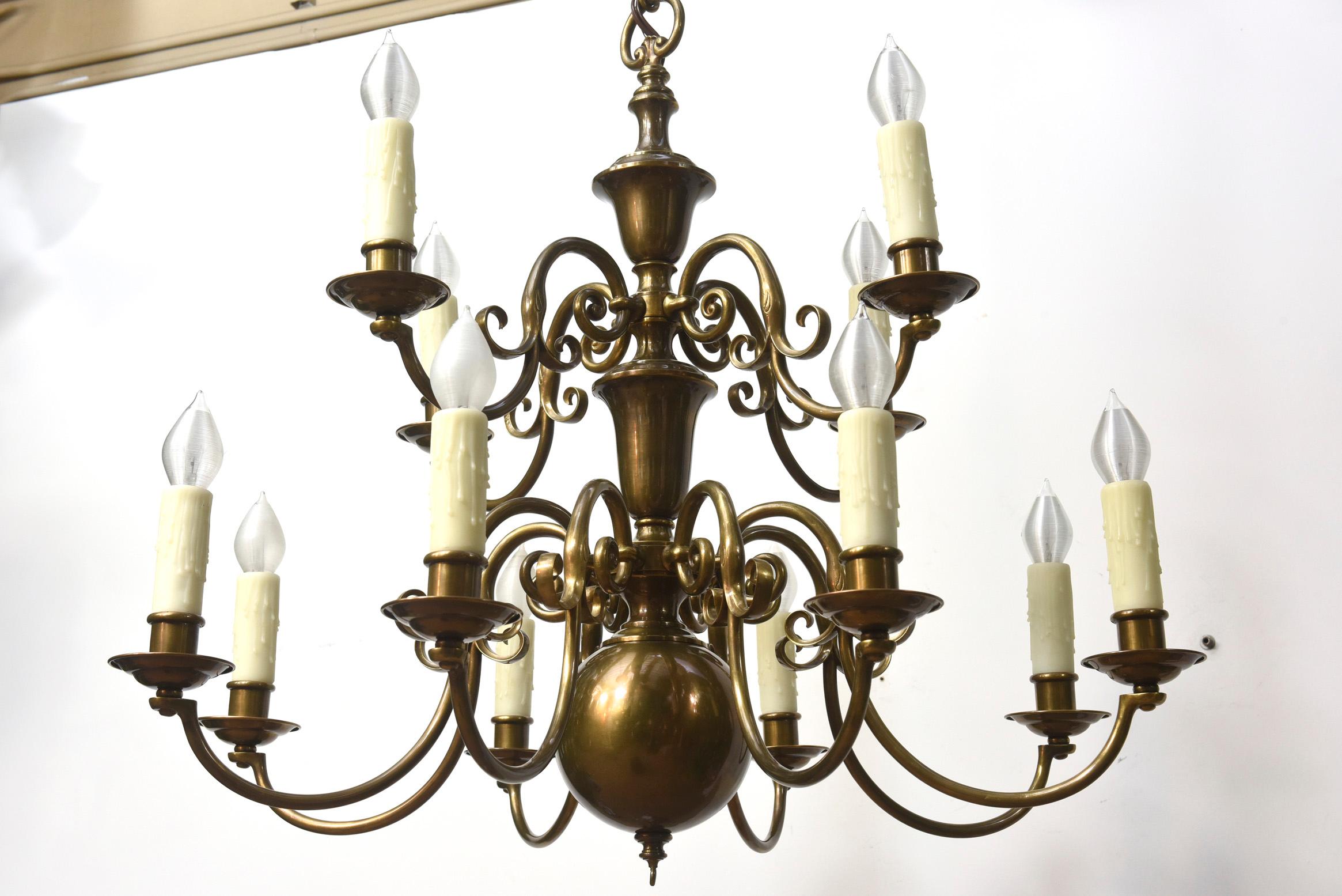 Twelve Light Colonial Chandelier. Brass with a dark patina. C. 1900. Completely rewired and restored, ready to hang.

Dimensions: 
Height: 44