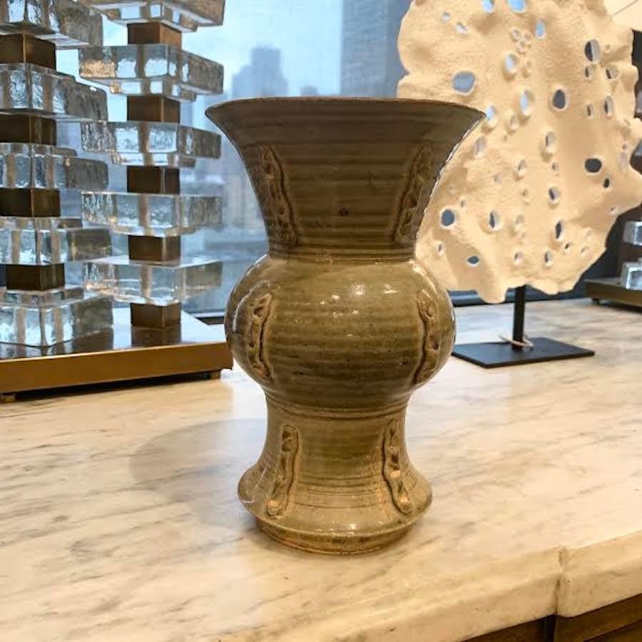 Contemporary Chinese two tier vase with decorative embellishments and horizontal ribs on the body of the vase.
Light olive colored glaze.

 