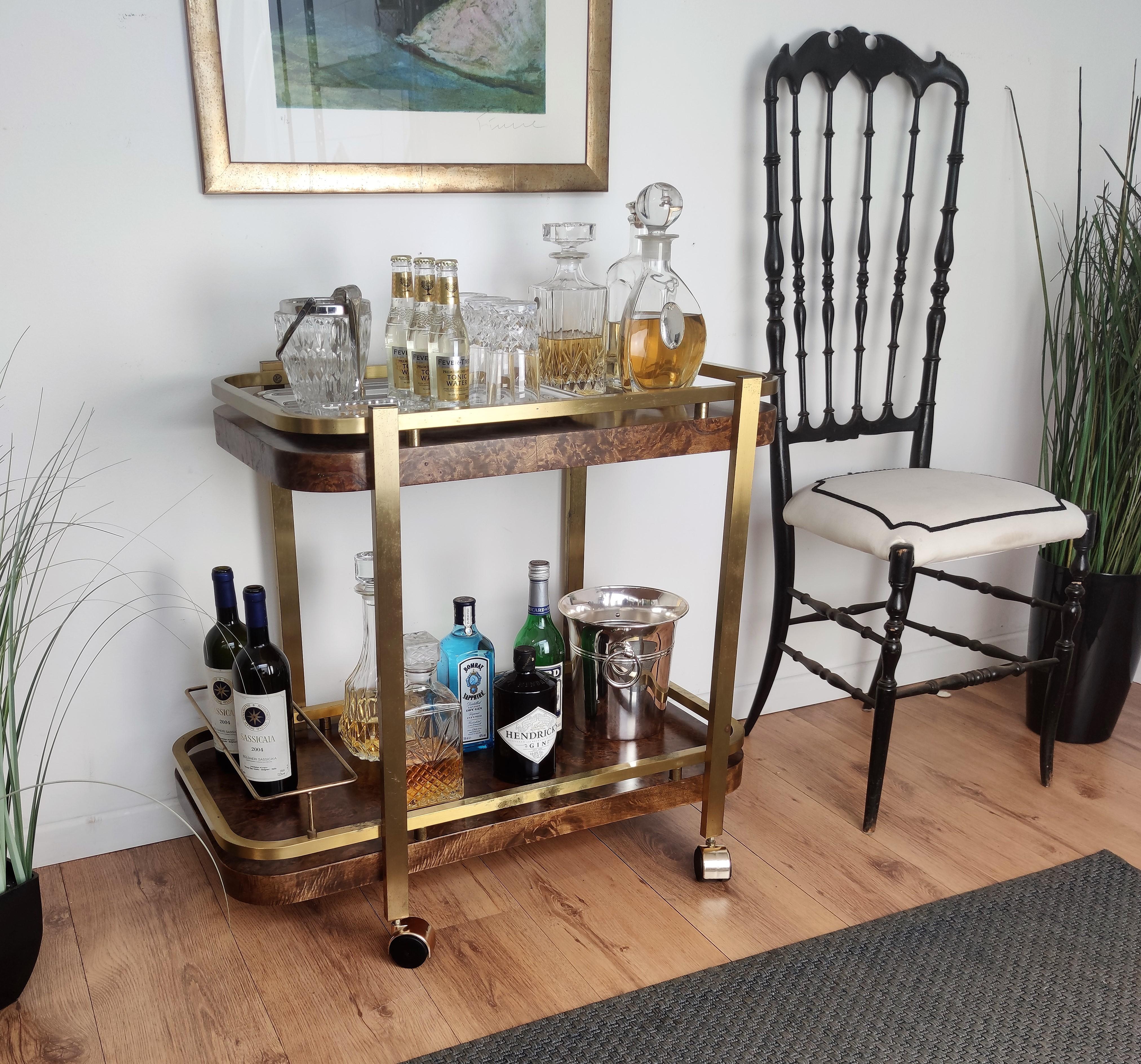Beautiful and stylish vintage 1970s Italian two-tier wood burl and brass bar cart with frame for bottle holder. Very good condition. A great piece that perfectly adds to every home decor the typical glitz, glamour and gold of Hollywood Regency