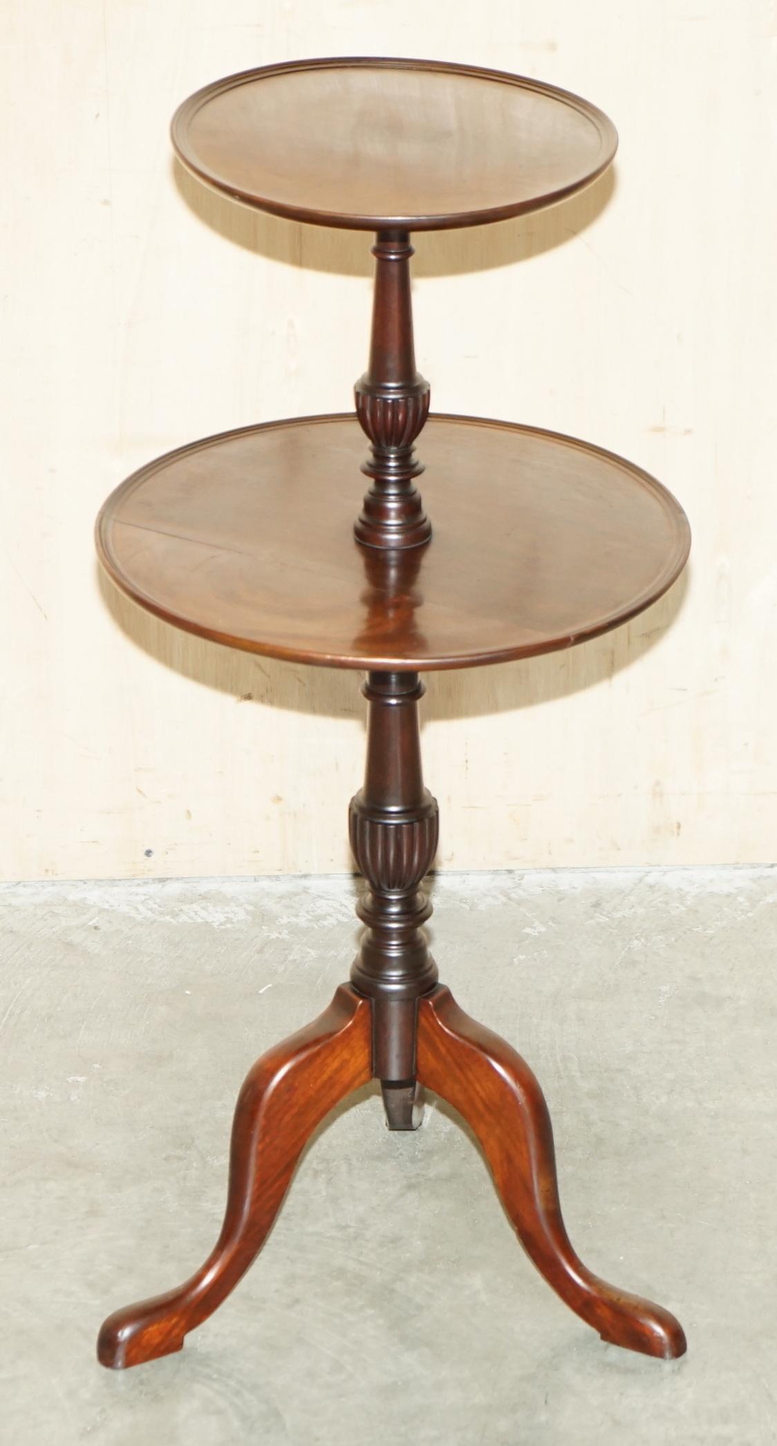 Royal House Antiques

Royal House Antiques is delighted to offer for sale this lovely circa 1920's tall two tiered tripod table with lazy Susan style rotating middle bottom shelf

Please note the delivery fee listed is just a guide, it covers within