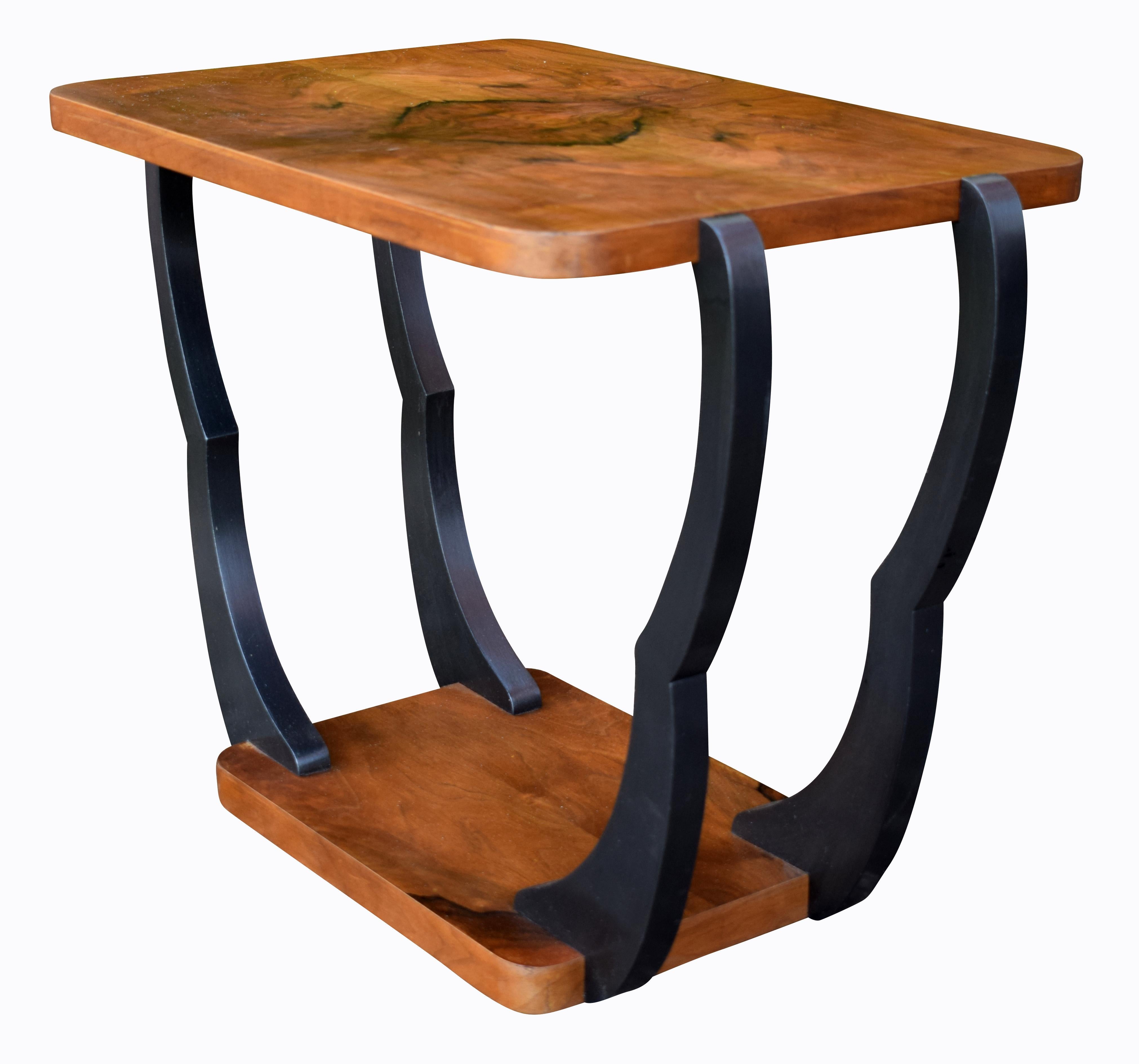 This is a stunning looking table with superb deco design and shape, dating to the 1930s. Ideal size for modern day use and easily integrated for most rooms. The ebonised distinctive looking legs contrasts beautifully with the highly figured walnut