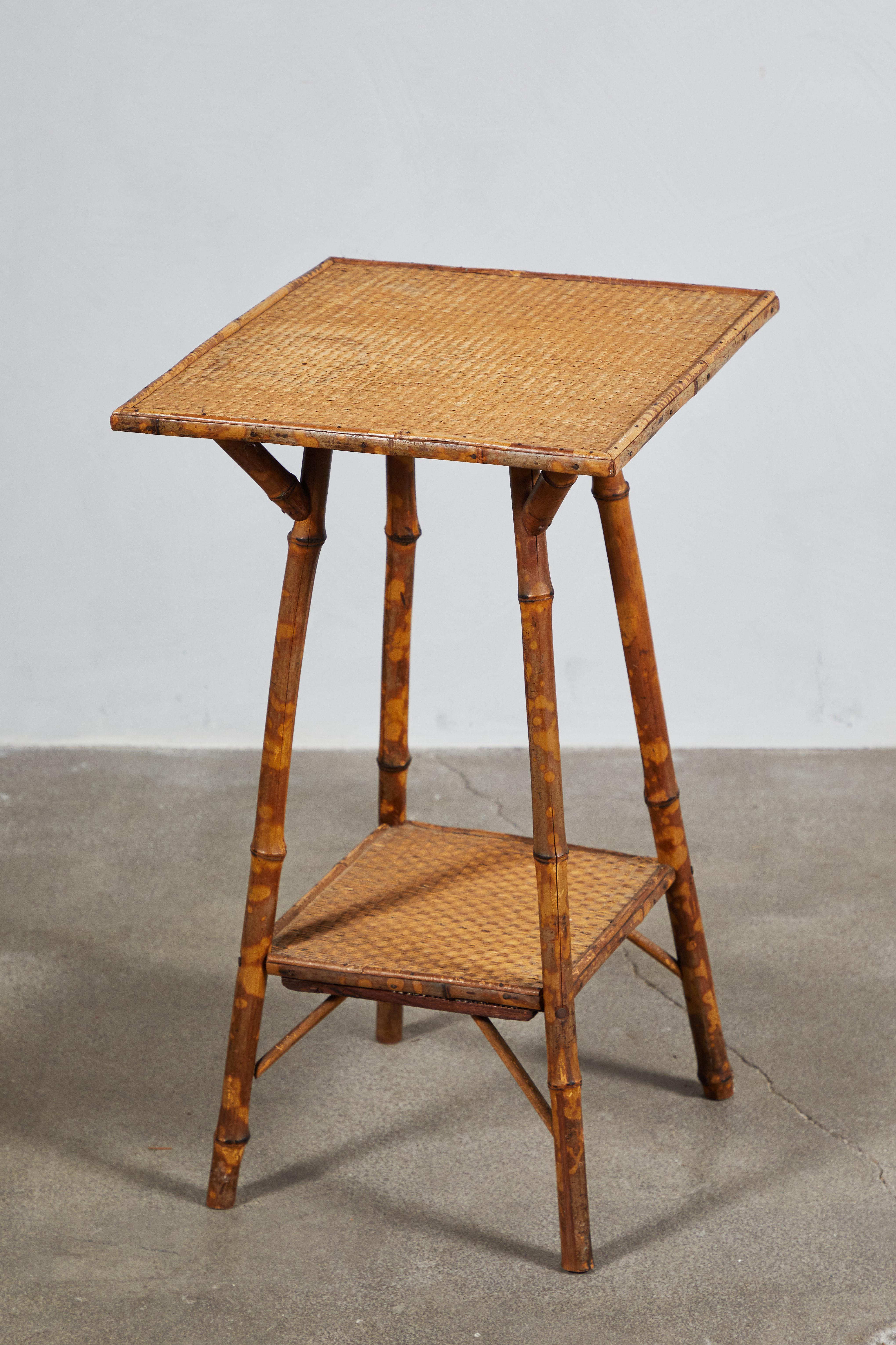 Two-tiered bamboo side table.