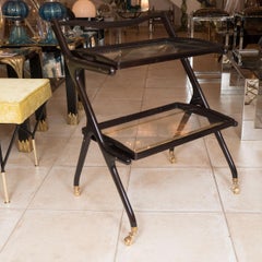 Two tiered ebonized wood and glass rolling cart