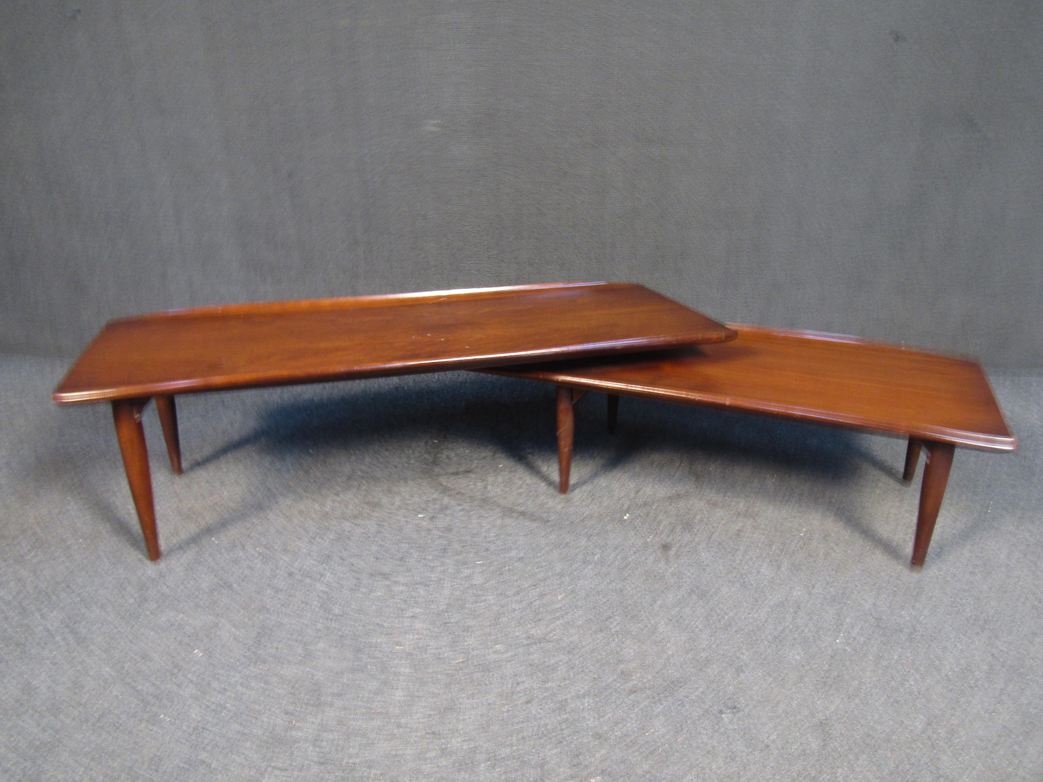 With a unique two-tiered swiveling design, this vintage coffee table can be adjusted to fit different spaces. Please confirm item location with seller (NY/NJ).
