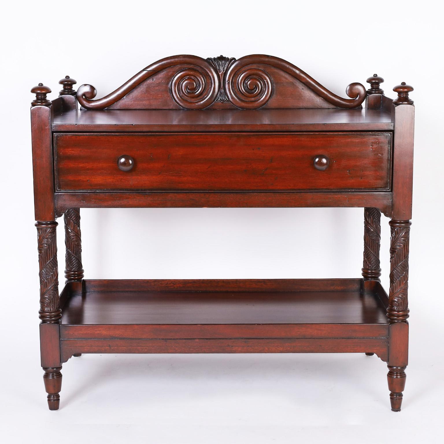British colonial style two tiered server or stand crafted in mahogany with a West Indies style, a carved gallery over one drawer, having carved and beaded supports and turned feet. Signed Ralph Lauren in the drawer.