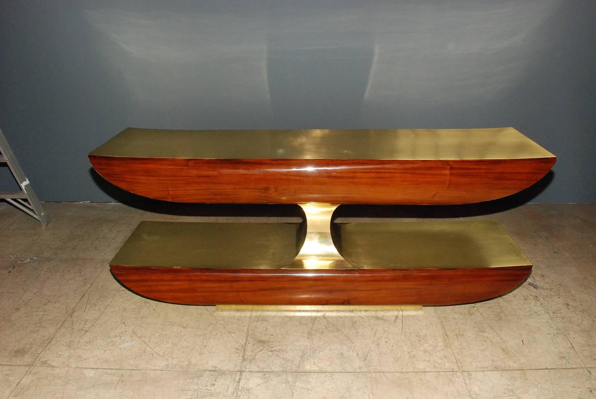 Two tiers bar or console table with solid mahogany front and solid brass the back side also single large drawer. Finish is high gloss brass crystal coat.