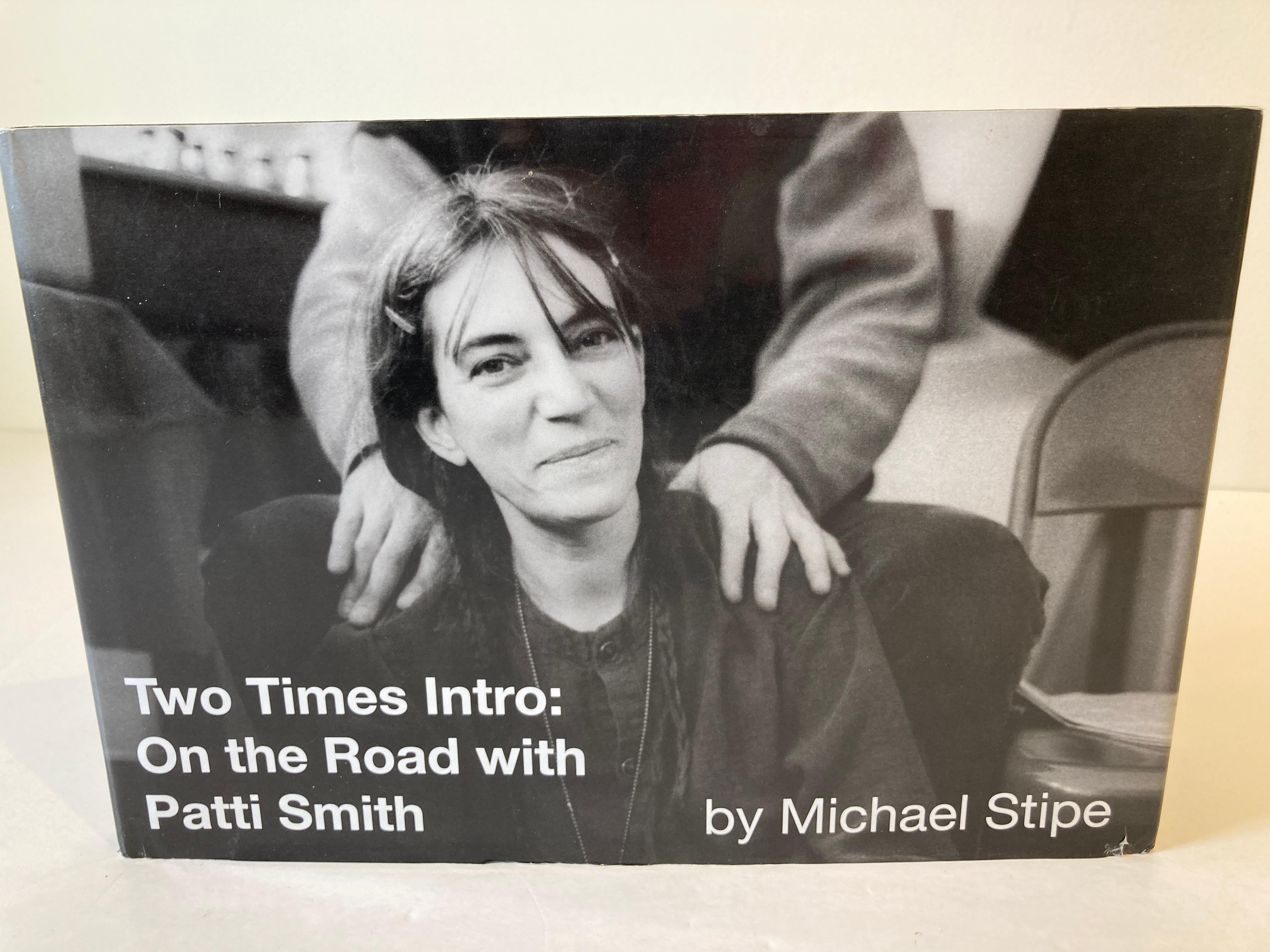 Two Times Intro: On the Road with Patti Smith
by Michael Stipe.
Offers a behind-the scenes, photographic look at a 1996 concert tour with the legendary Patti Smith, presenting more than one hundred images that capture life on the road with the