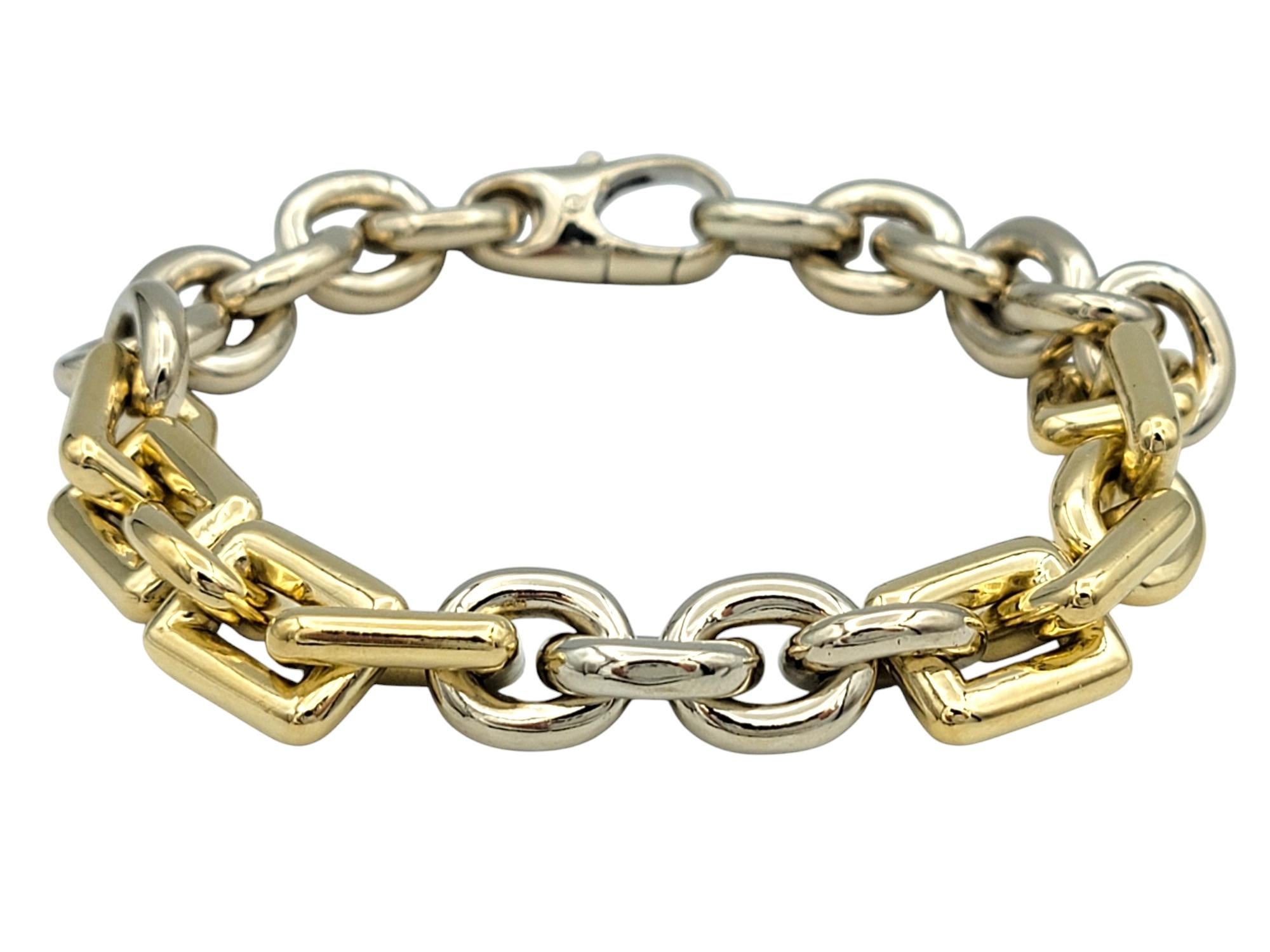 Add a modern twist to your jewelry collection with this exquisite two-tone circle and square chain link bracelet. Crafted in a harmonious blend of 14 karat yellow and white gold, this bold, heavy bracelet seamlessly combines sleek geometric elements