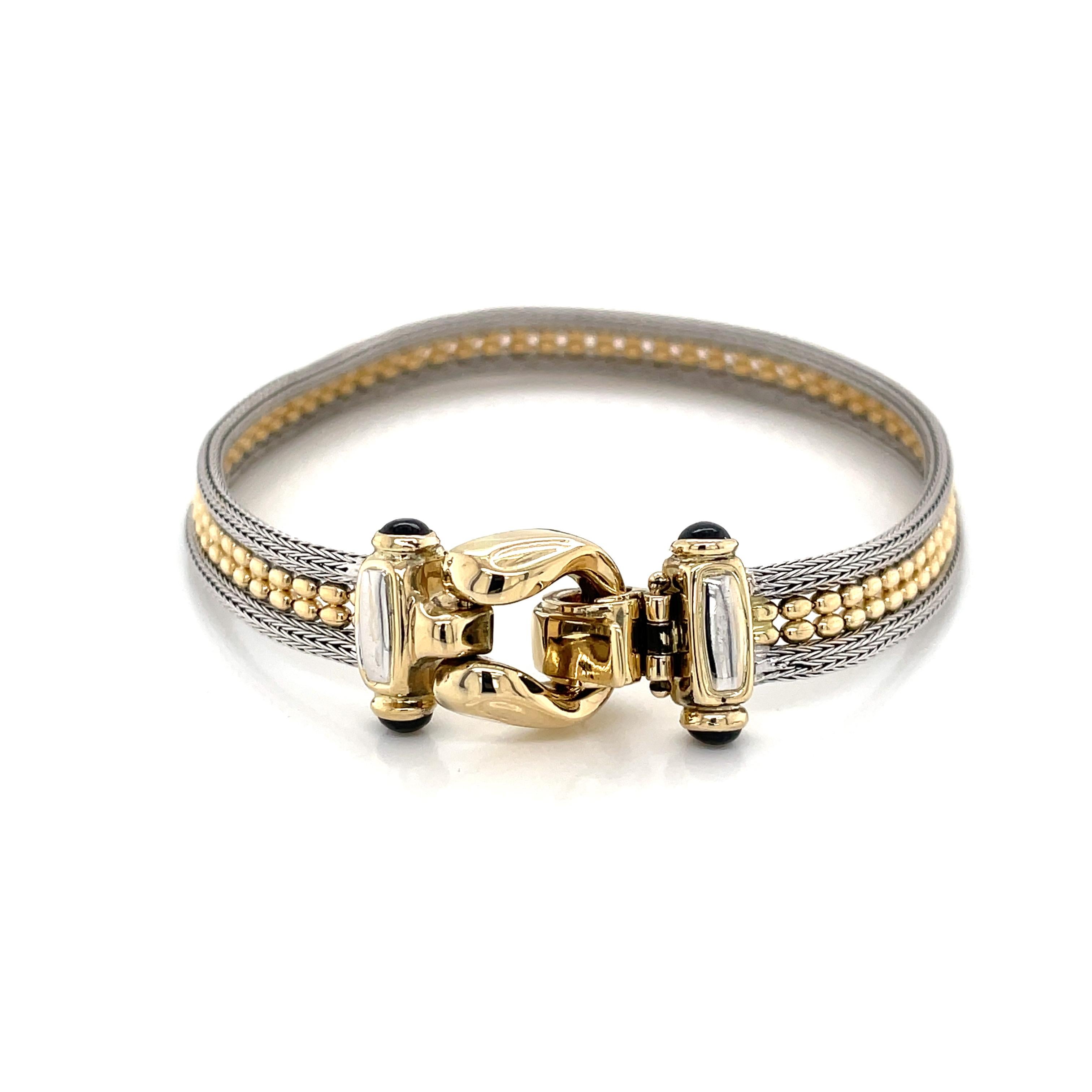 A custom gold buckle clasp capped with black oynx cabochon tendrils is featured on this unique and flexible woven gold mesh ribbon inspired bracelet of two-tone fourteen karat 14K gold with beaded center detail. Slender in profile at 1/4 inch wide