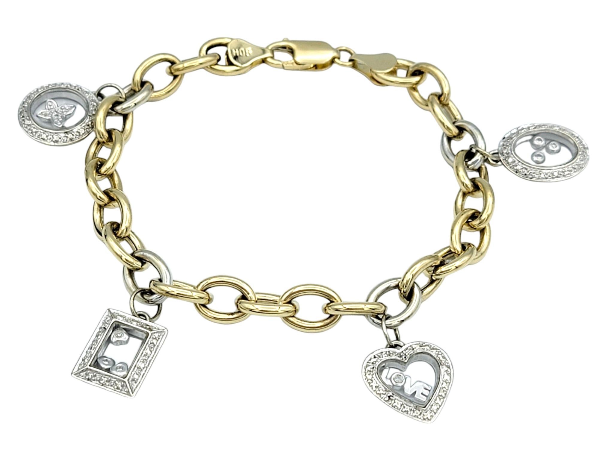 Embrace modern elegance with this exquisite two-tone 14 karat yellow and white gold oval link bracelet, adorned with four floating charms. Each white gold charm features a unique shape—round, heart, oval, and rectangle—and is crafted with glass