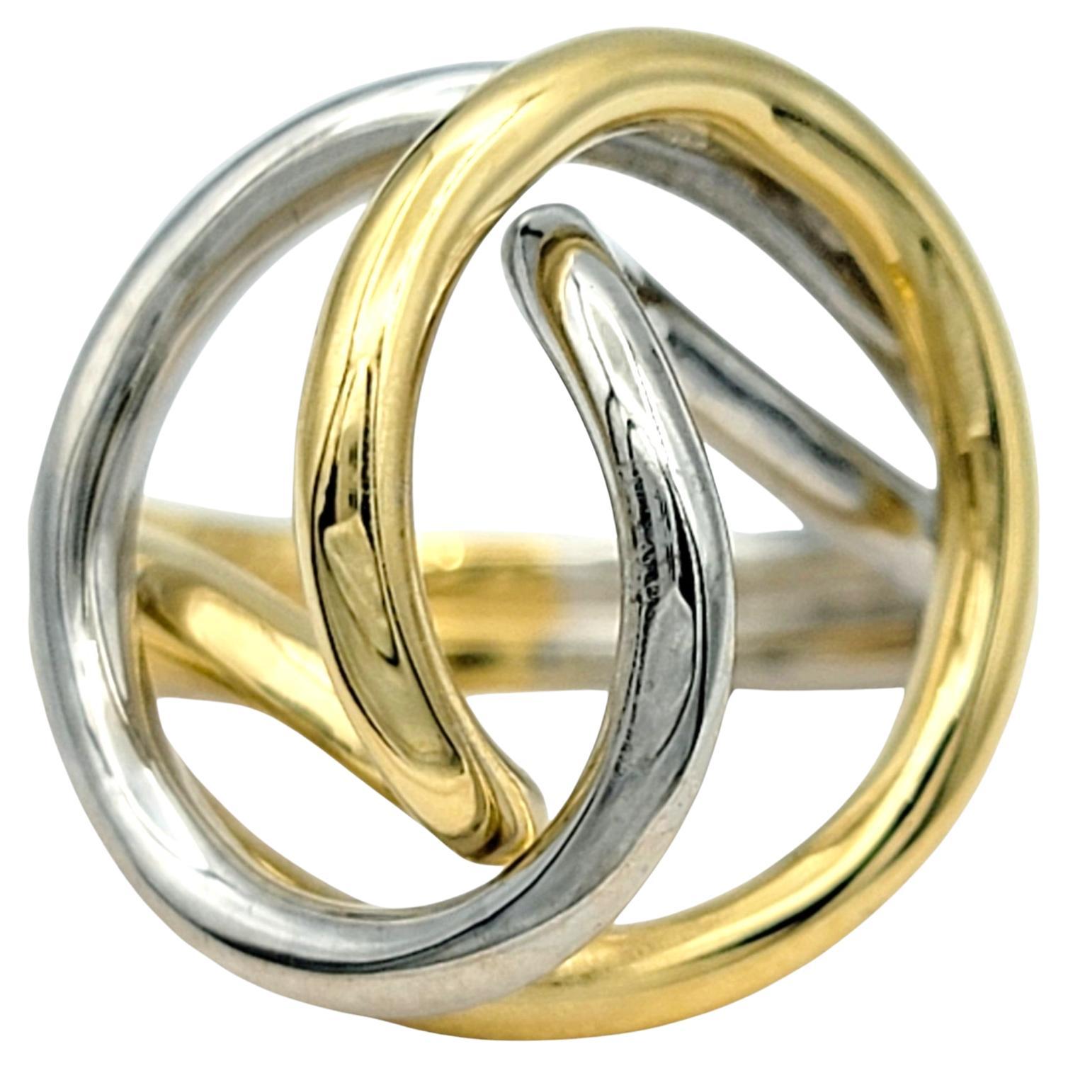 Ring Size: 6.5 

Celebrate the beauty of endless elegance with this captivating ring, crafted in a seamless blend of 18 karat white and yellow gold. The two tones intertwine in an open, flowing twist design, symbolizing infinity and unity. The sleek