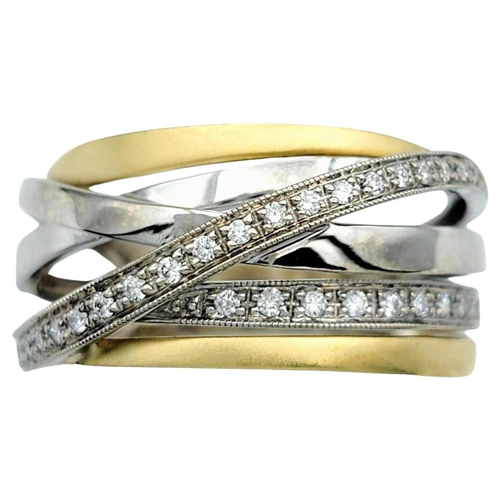 Ring Size: 8 

This exquisite diamond band ring boasts a sophisticated crisscross design, crafted from lustrous 18 karat white and yellow gold. The intertwining bands create an elegant and dynamic pattern that showcases the brilliance of the