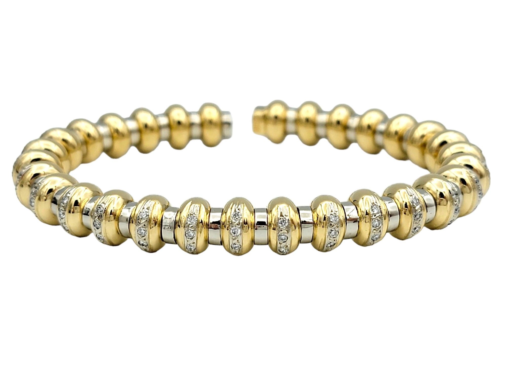 The inner circumference of this bracelet measures 5.88 inches and will comfortably fit up to a 5.75 inch wrist. 

This flexible cuff bracelet boasts a textured ridged design, alternating between 18 karat white and yellow gold, creating a dynamic