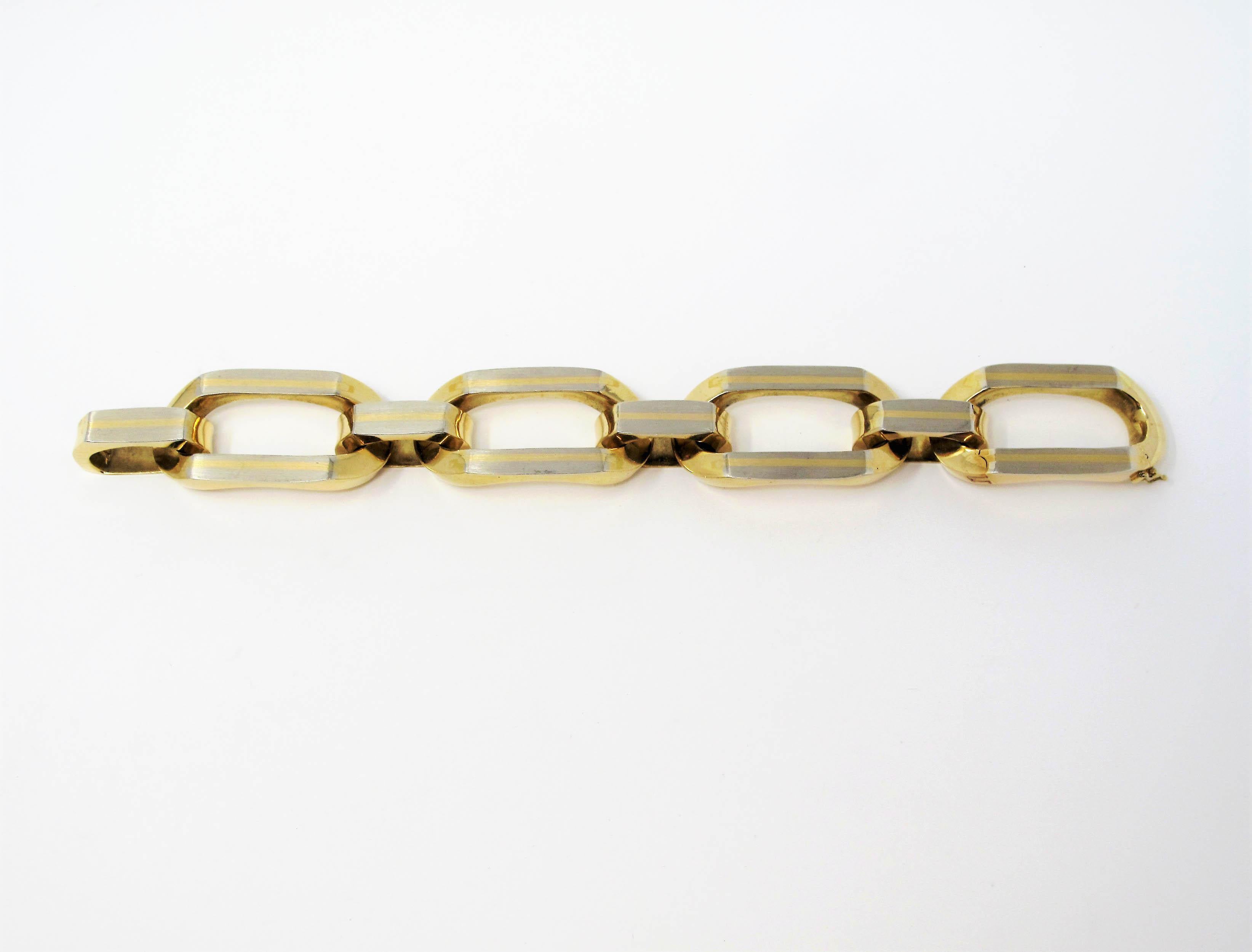 Incredible sleek two tone gold link bracelet in a chunky, over sized style. This bracelet was built to make a statement! The extra large links offer a subtle contrasting yellow and white gold design and feature a smooth flash and satin finish. This