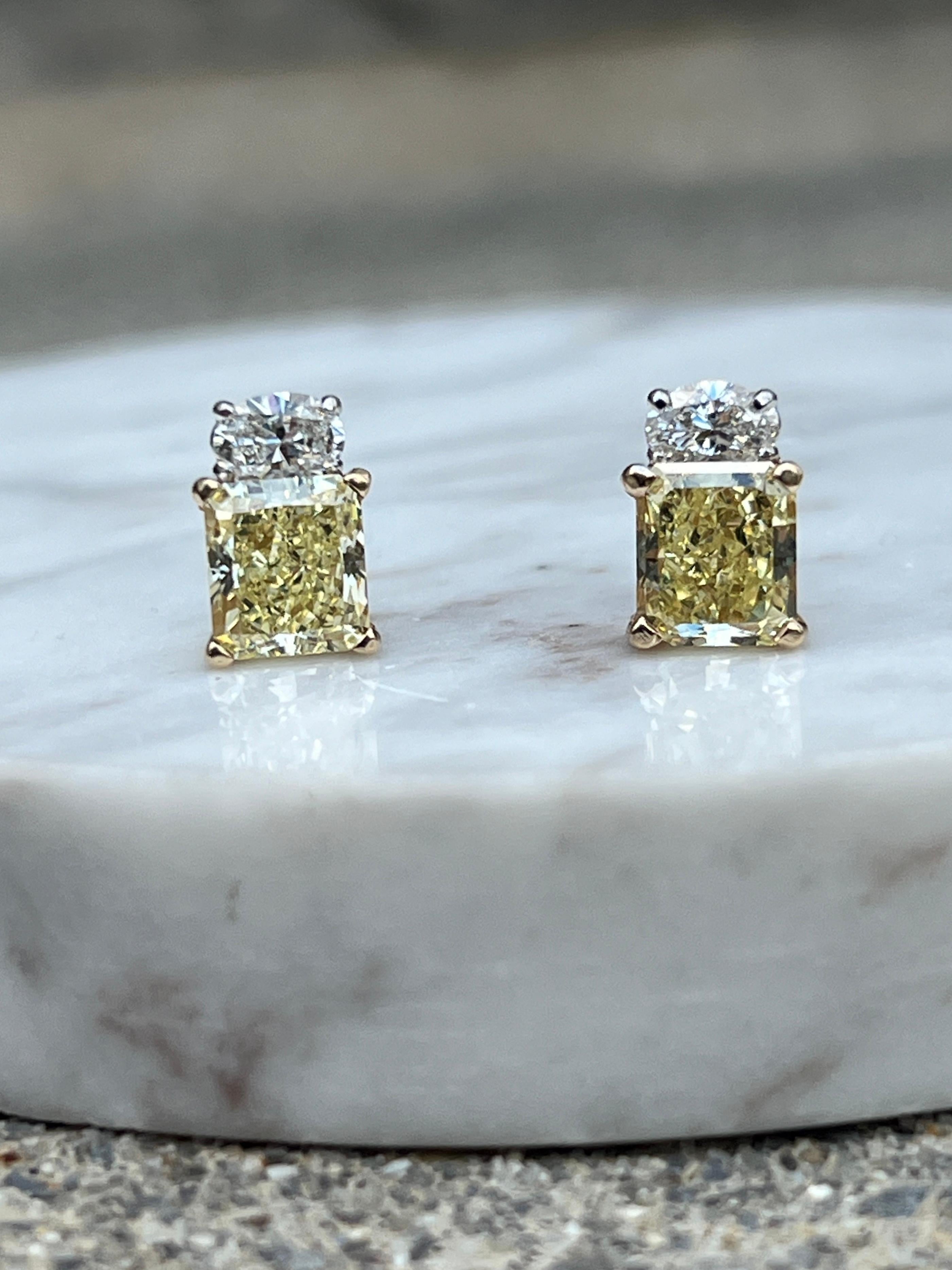 These stunning contemporary earrings combine the richness of 18 karat yellow gold and 14 karat white gold, creating a striking contrast that enhances their elegance. Each earring is set with one radiant cut natural fancy yellow diamond, with a total