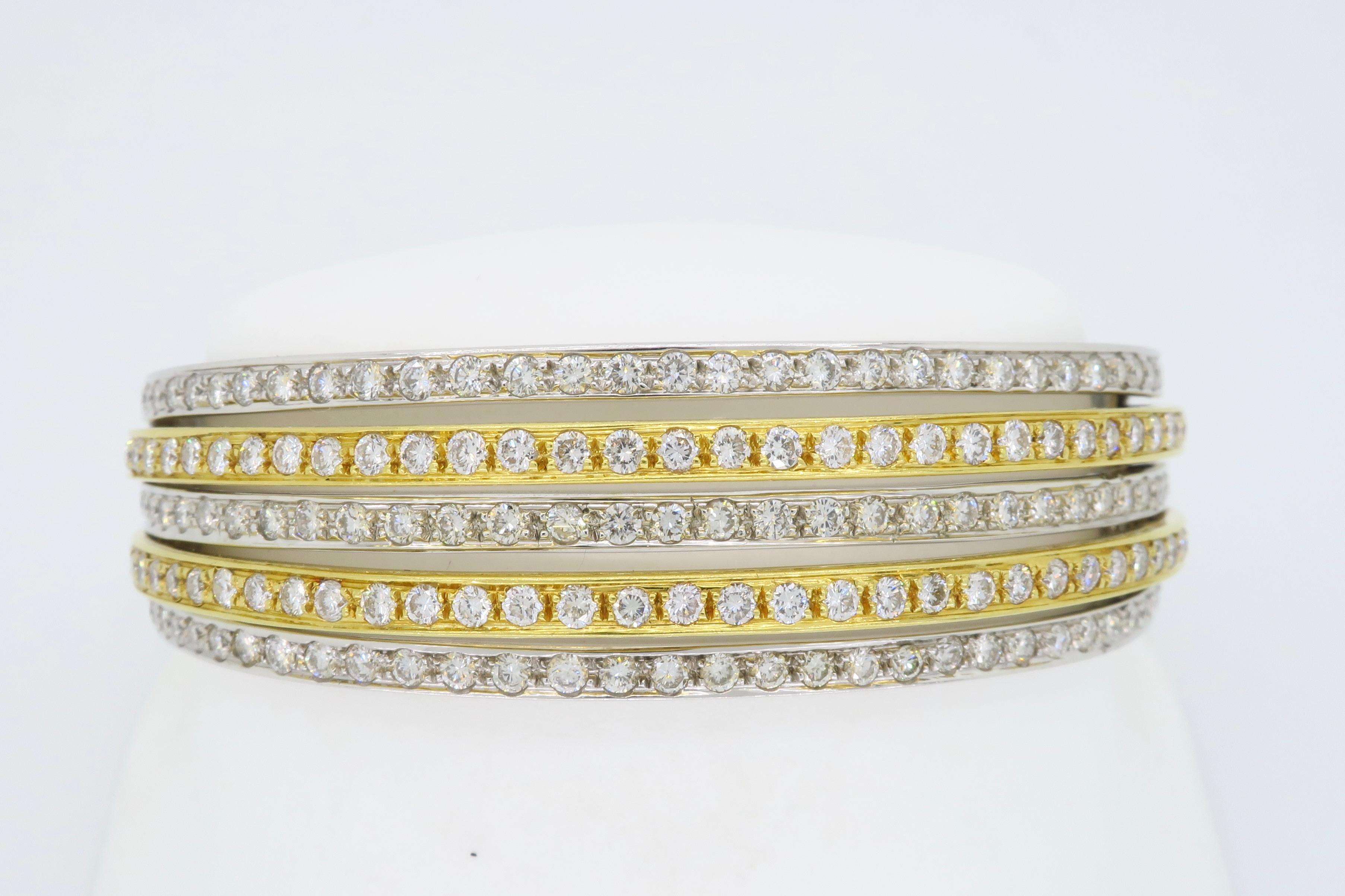 Unique 18k two tone gold diamond bangle featuring 5 elegant rows of Round Brilliant Cut Diamonds, totaling approximately 6.21CTW

Diamond Carat Weight: Approximately 6.21CTW
Diamond Cut: 183 Round Brilliant Cut Diamonds
Color: Average G-I
Clarity: