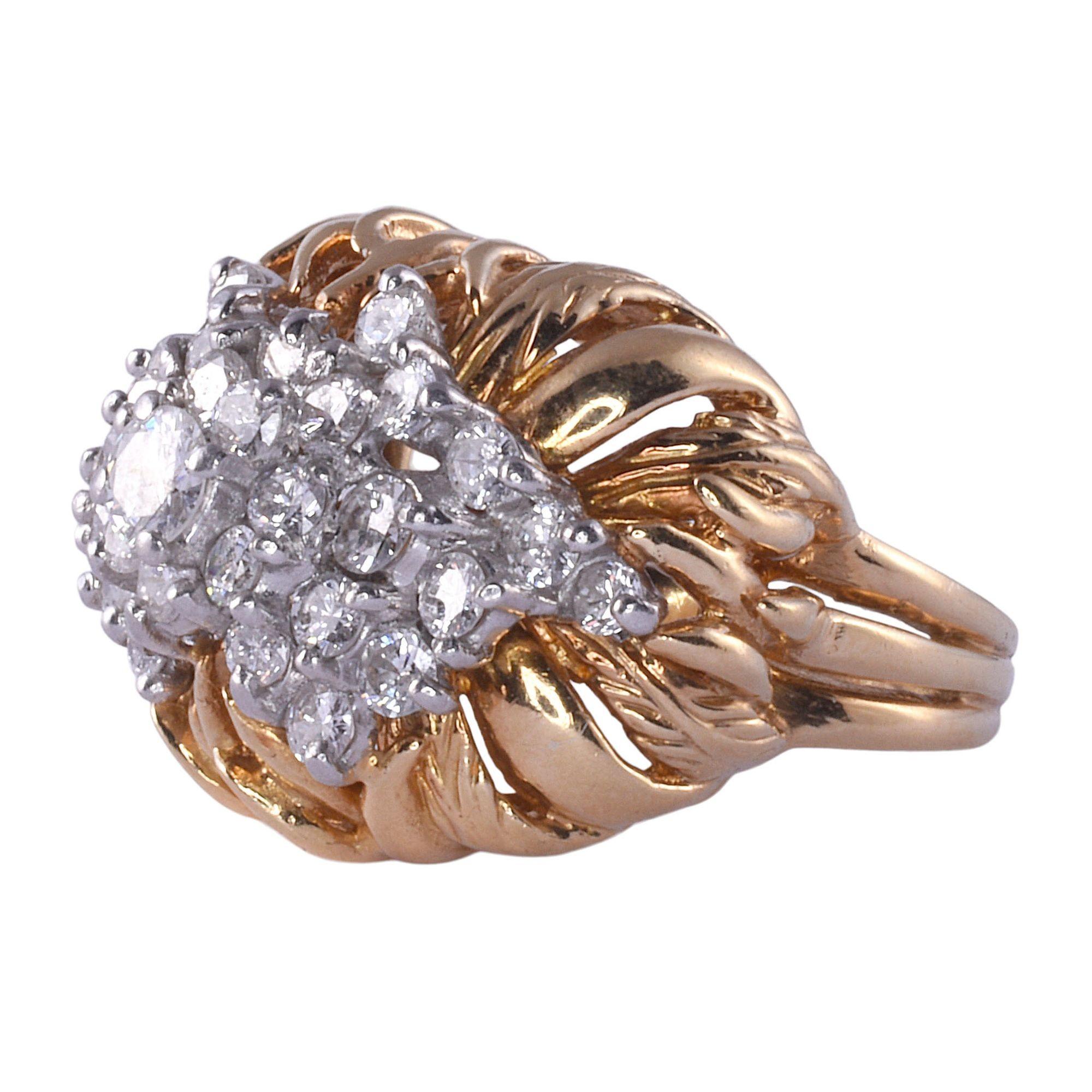 Vintage two tone 18K gold diamond cluster ring, circa 1960. This vintage ring is crafted in 18 karat yellow gold and 18 karat white gold. It features a cluster of diamonds at 1.35 carat total weight with VS clarity and F-H color. This vintage