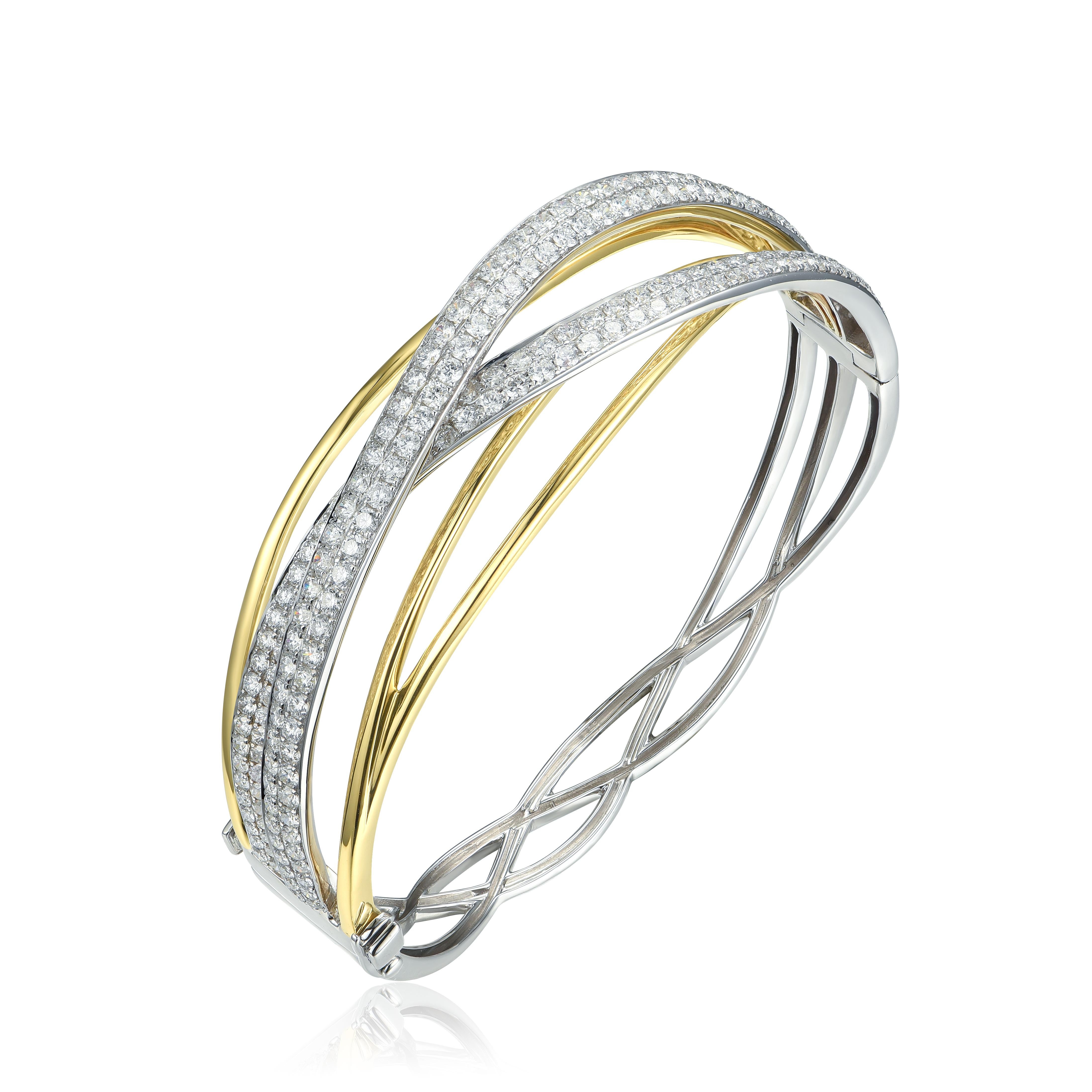 This crossover diamond bracelet gives you a stacked look with just one bracelet. The two tones of gold make it very versatile. It has 6.04cts of G color, VS2 clarity, round brilliant diamonds set in 18k white gold with yellow gold as well. 