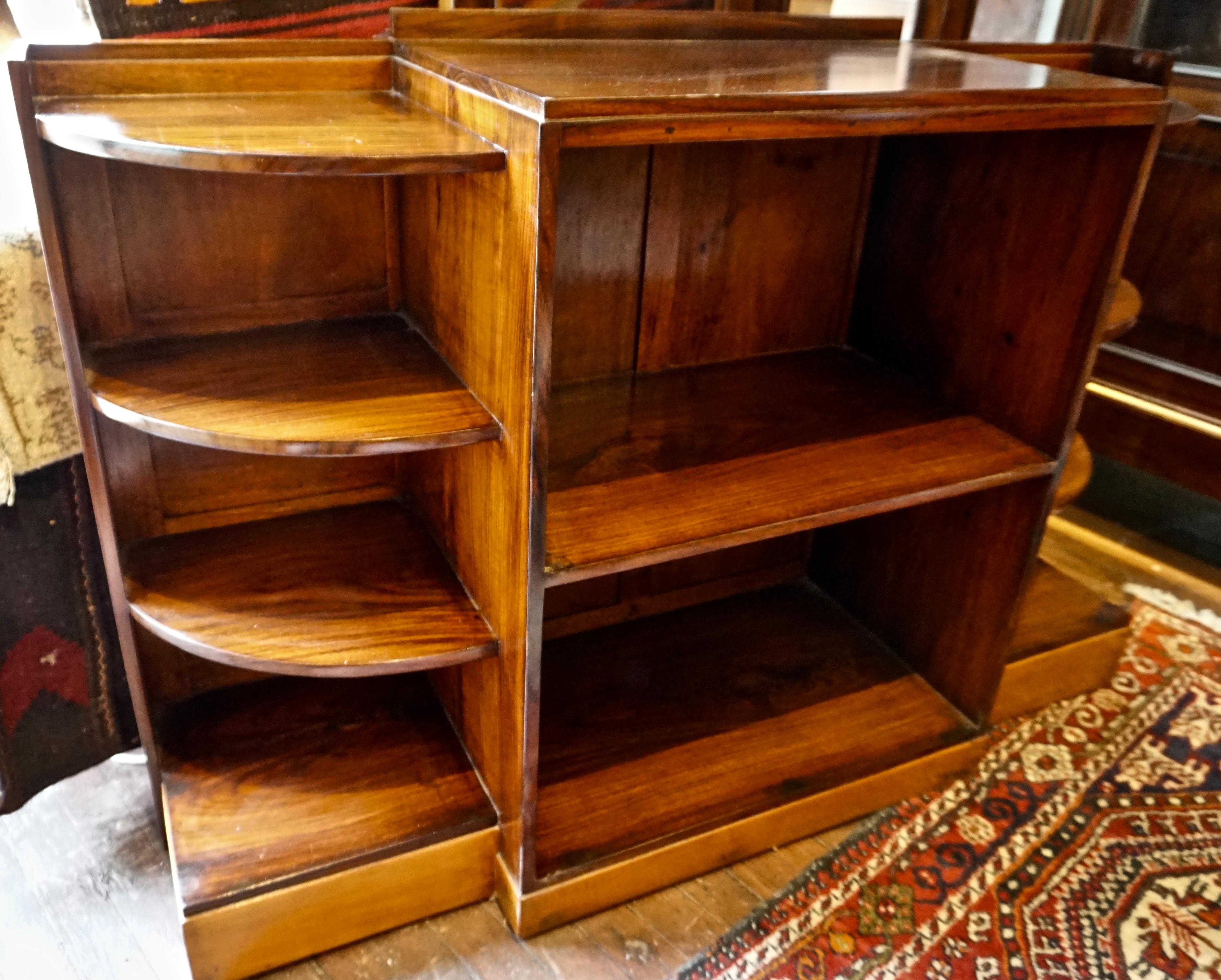 Solid Art Deco display cum bookshelf cabinet handcrafted from rosewood and teak with paneled hard back and curved edges. Shows free flowing grains and in good condition with a nice two-tone look. British India, circa 1930s.
 
 