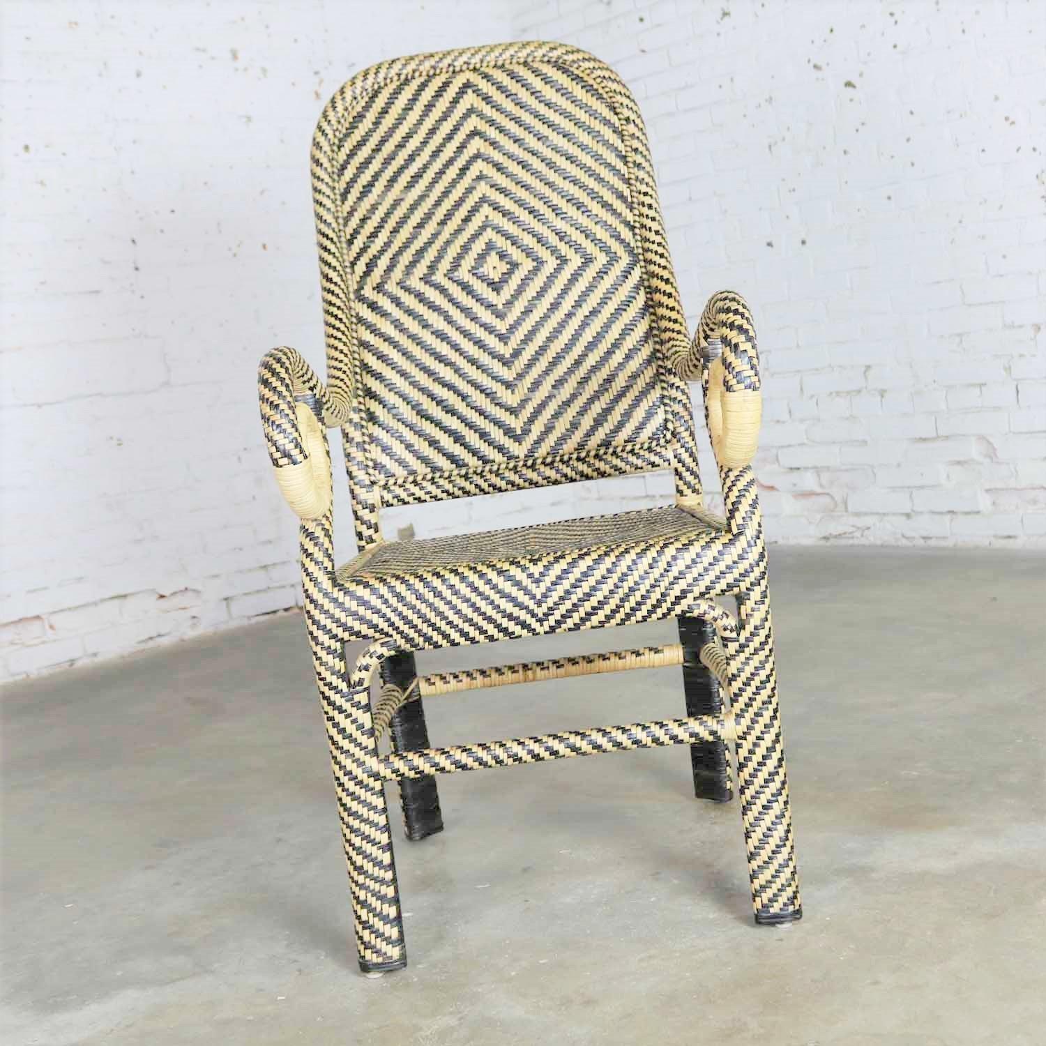 Handsome vintage two-tone rattan wicker chair with a chevron pattern, spiral arms and a tall rounded back. It is in fabulous vintage condition with no outstanding flaws. Please see photos, circa 20th century.

I don’t know if this came from a
