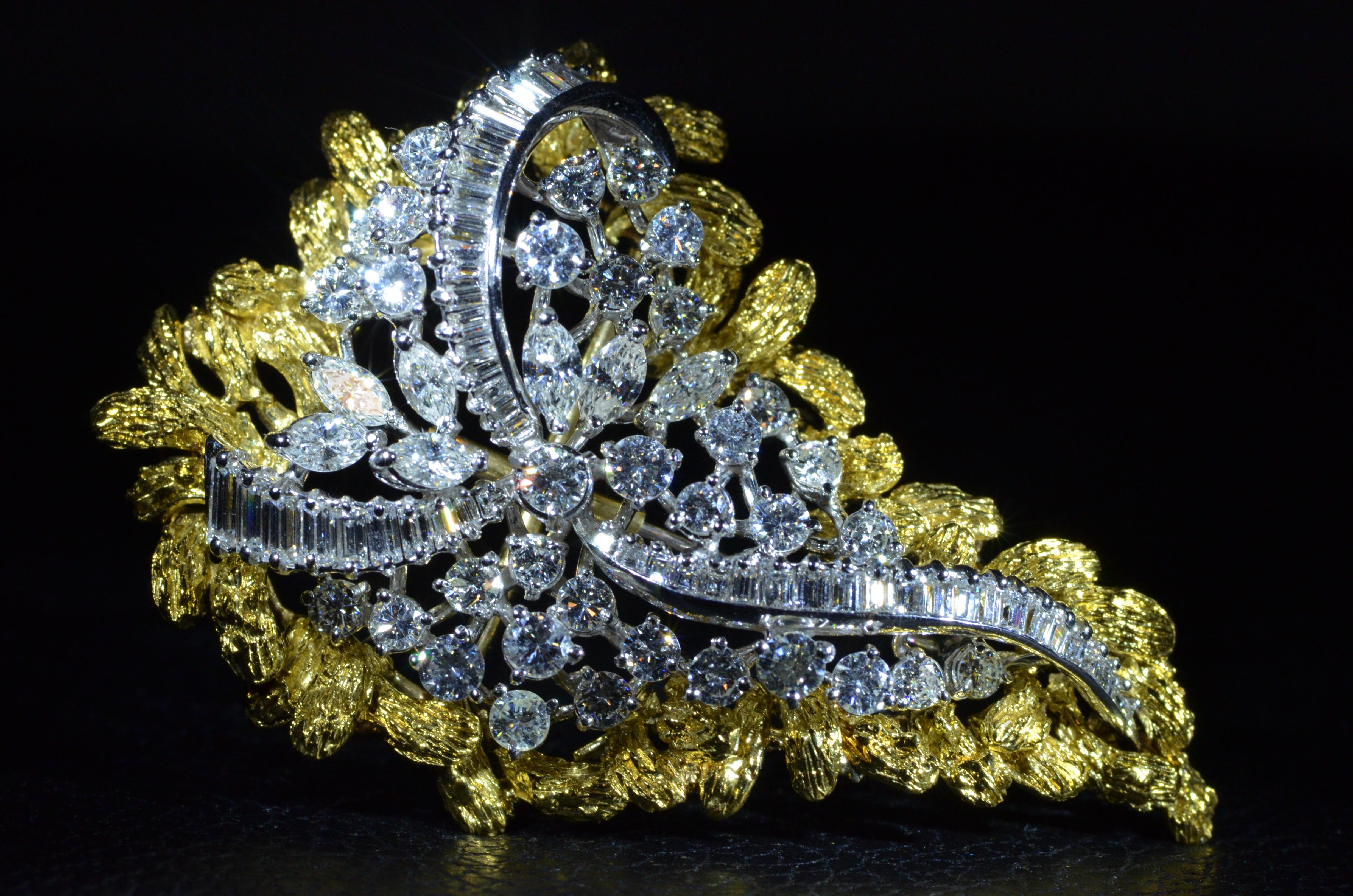 Impressive diamond brooch measuring approximately 2 1/2 inches in length set with approximately 7 1/2 carats in diamonds. The outside 18 Karat yellow gold frame is removable for multiple looks. The brooch can also be worn as a diamond pendant. 