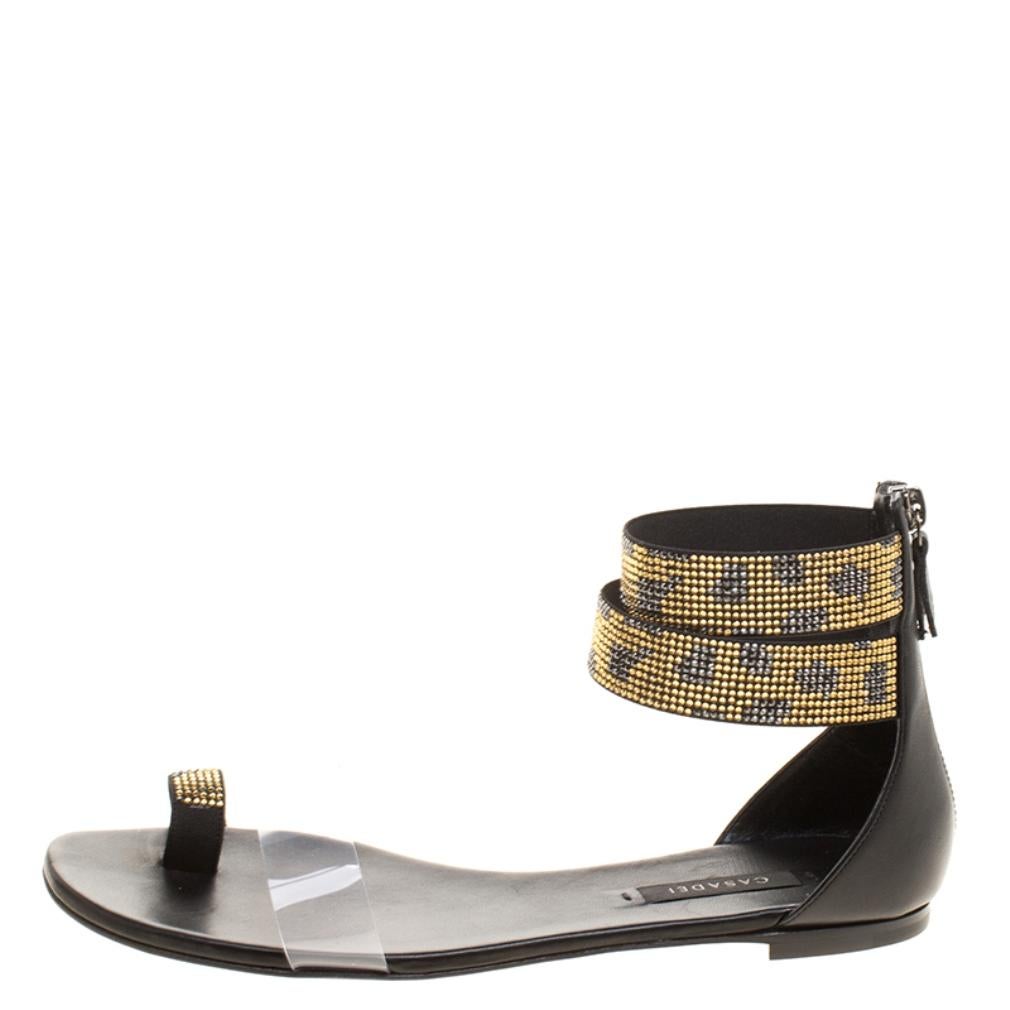 A pair of flats that do not compromise on the high fashion statement for everyday comfort, the Casadei Two Tone Crystal Embellished Ankle Cuff and PVC Vinil Flat Sandals are going to officially become a favourite of yours. The gunmetal tone hardware