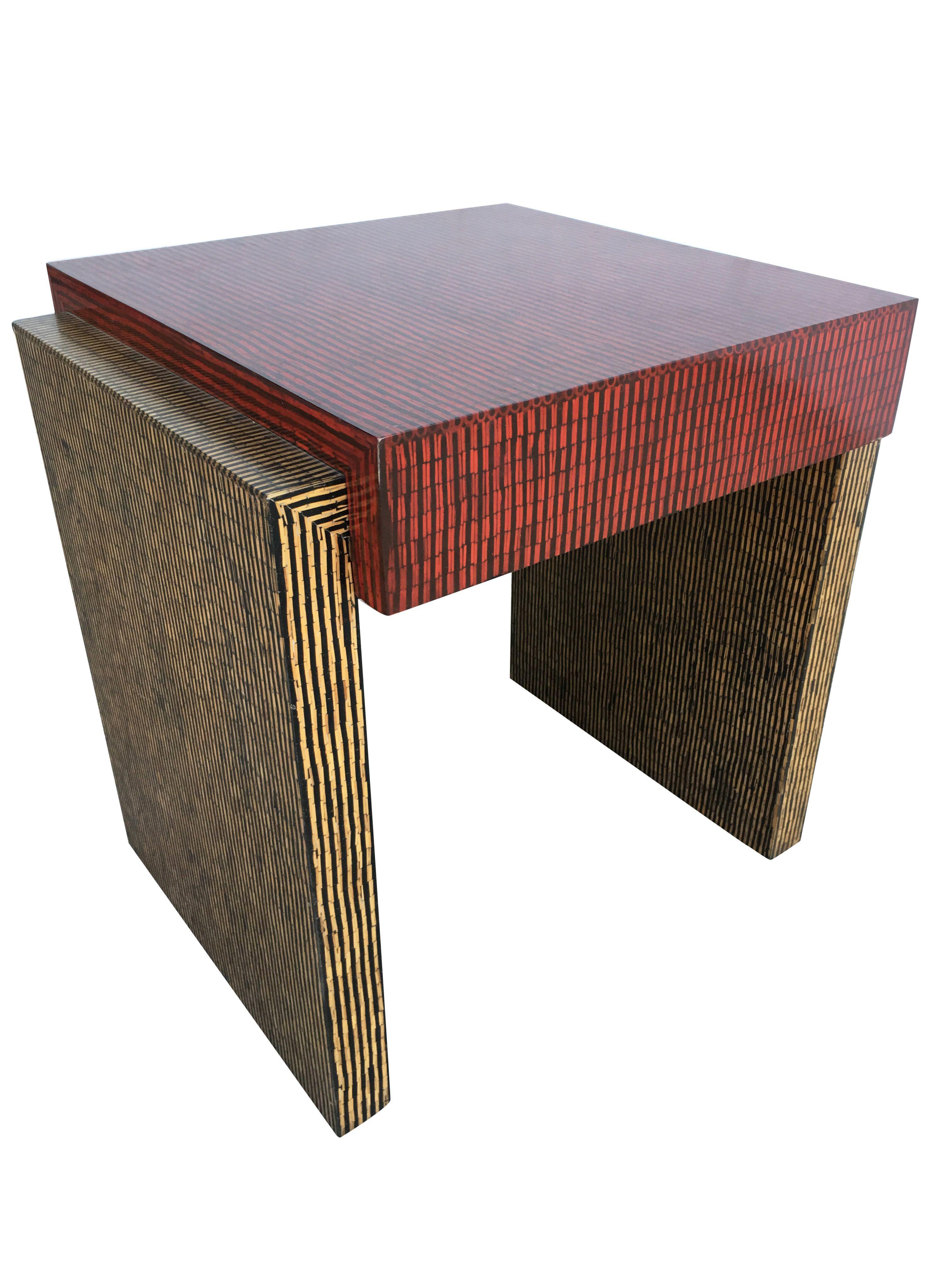 Two-tone cubist style side table pair with red and tan textured vinyl tops.