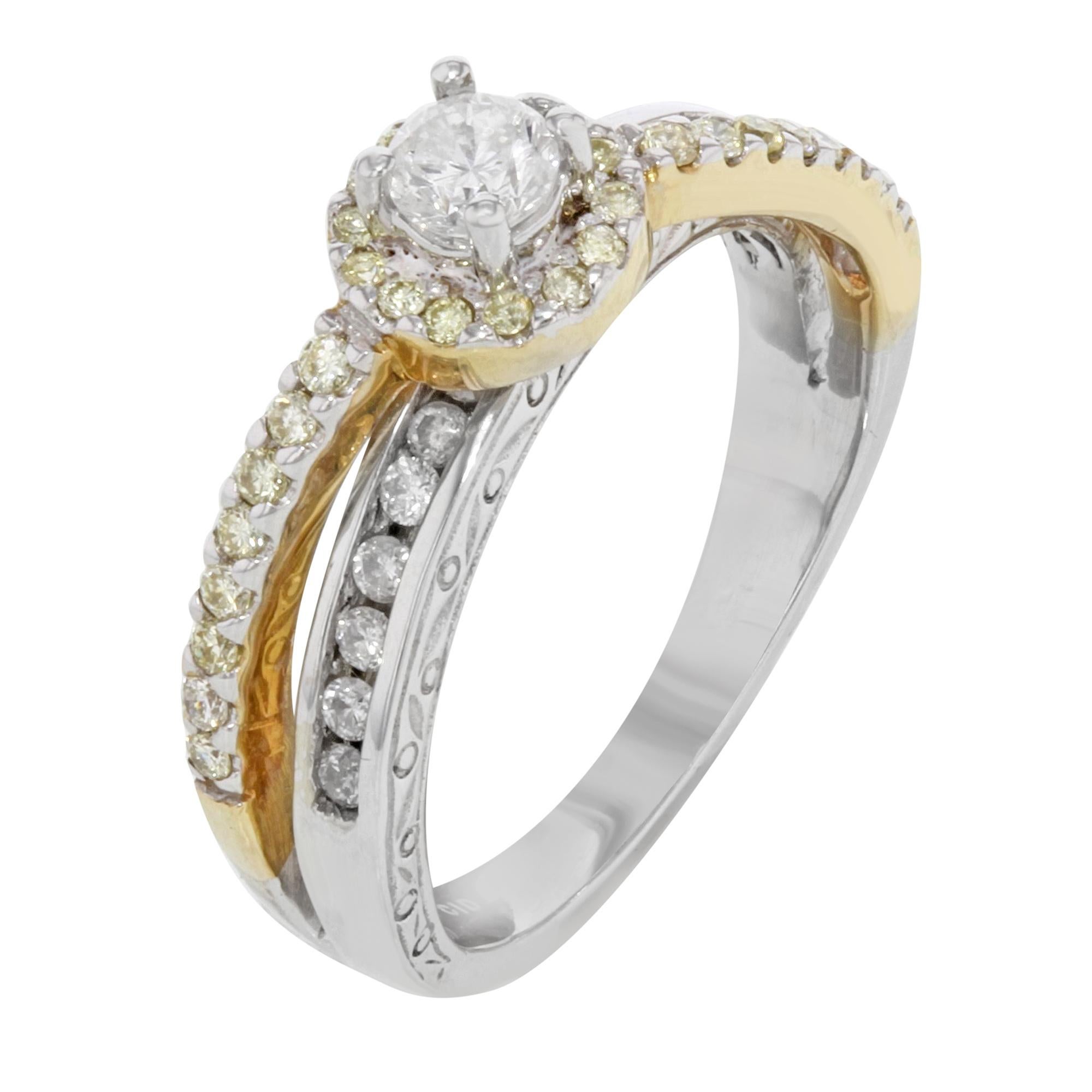 This beautiful ring is crafted in 14k white and yellow gold. Featuring a center round cut diamond accented with a line of round cut white diamonds in channel setting on white gold and a row of yellow diamonds in pave setting on yellow gold. Total
