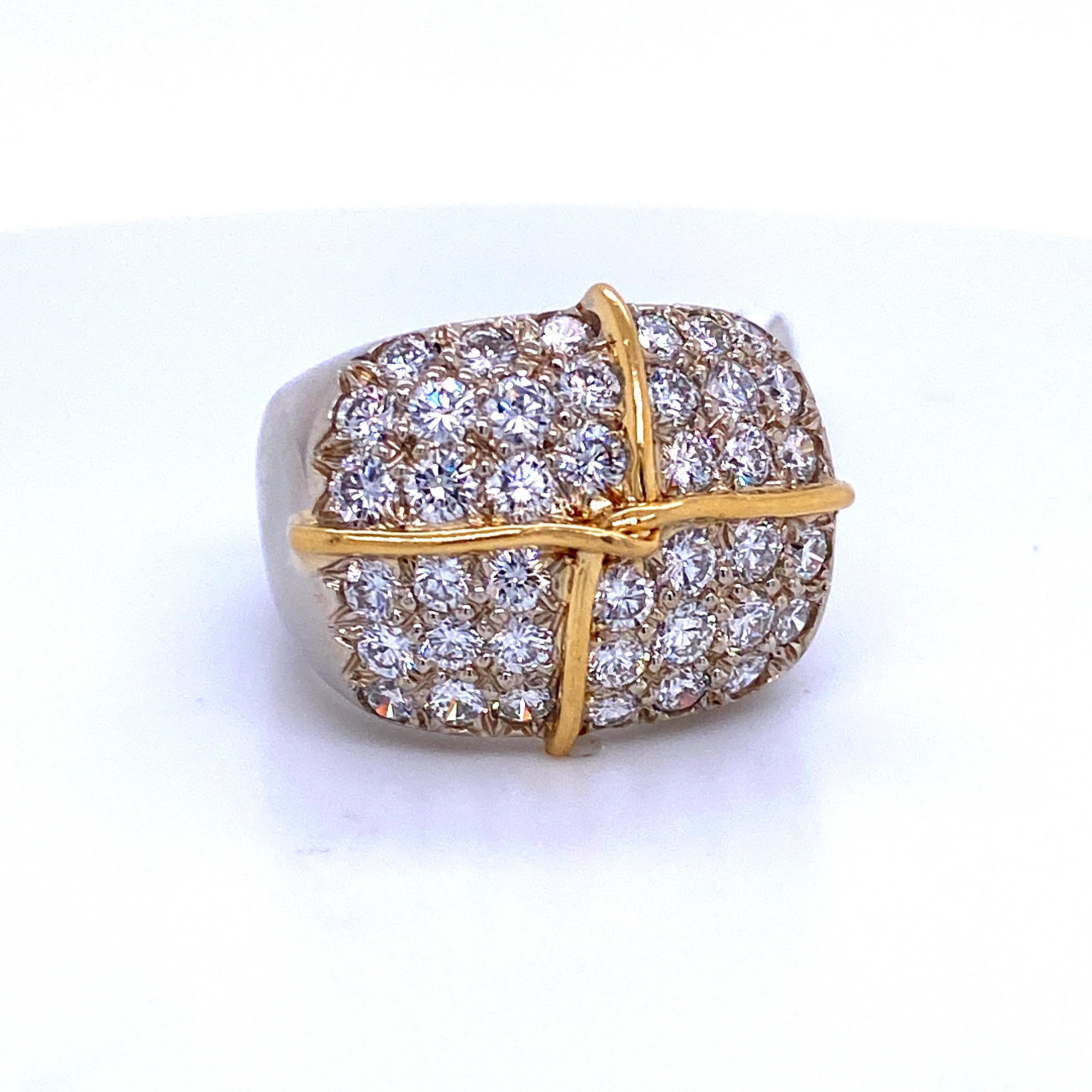 18K White gold ring featuring 40 round brilliants weighing 2.64 carats with a decorative 18k yellow gold ribbon motif trim. 
Average Stone: 0.07 PTS
Color G
Clarity SI

Size 6
Sizeable free of charge