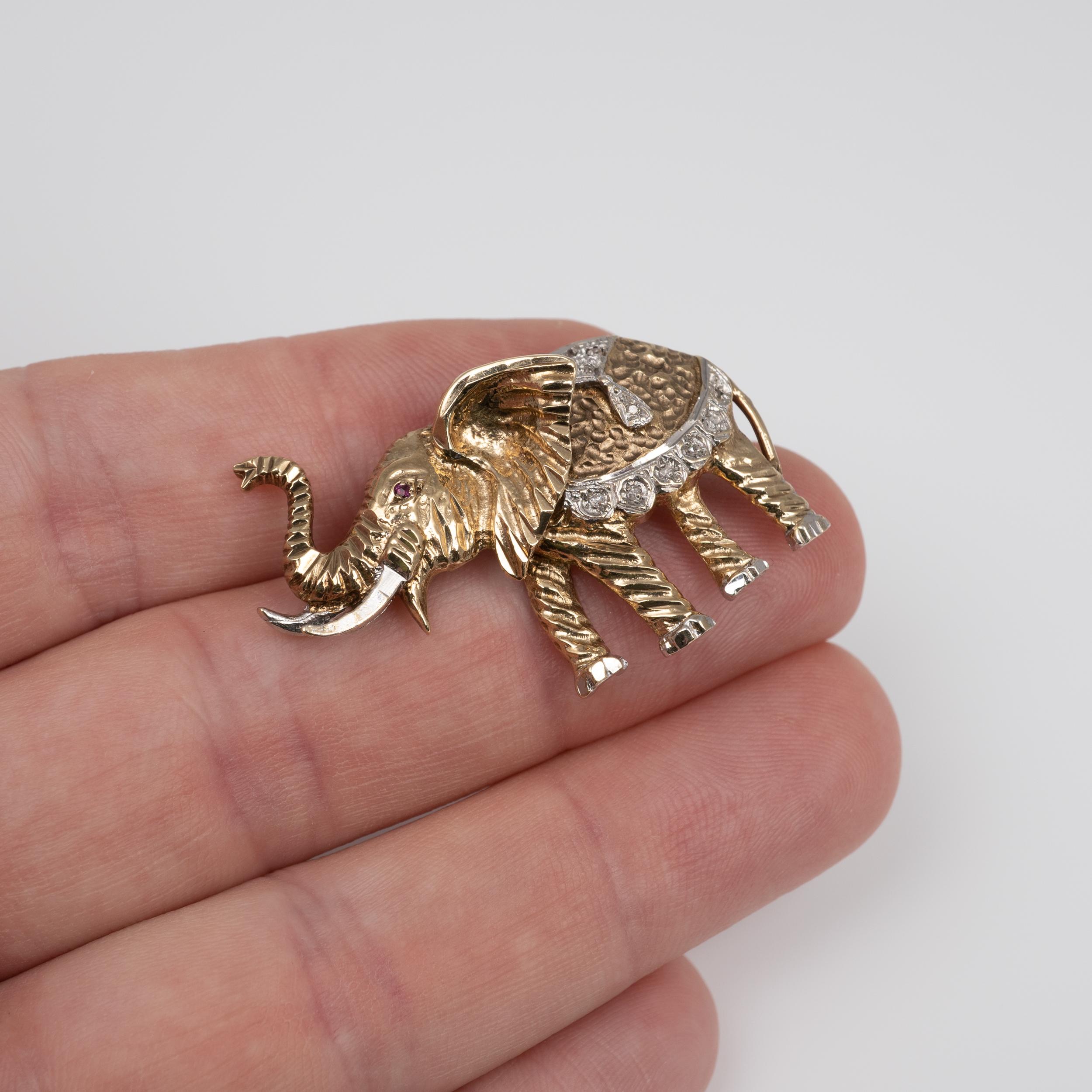 A fabulous vintage diamond and ruby yellow and white gold elephant brooch.

The two-tone gold elephant with trunk up is nicely crafted with a stylish textured pattern. It is set with diamonds and a single ruby to the eye.

The item is fully