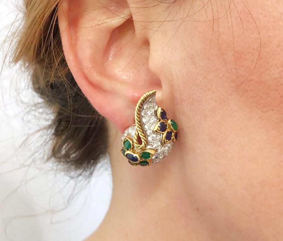 Diamond Sapphire Emerald Paisley Earrings in 18k White Gold and 18k Yellow Gold.

A pair of diamond pavé on-the-ear clips in paisley form with bursts of color, finished with an edge of gold twisted rope. Floral decor is comprised of faceted emeralds