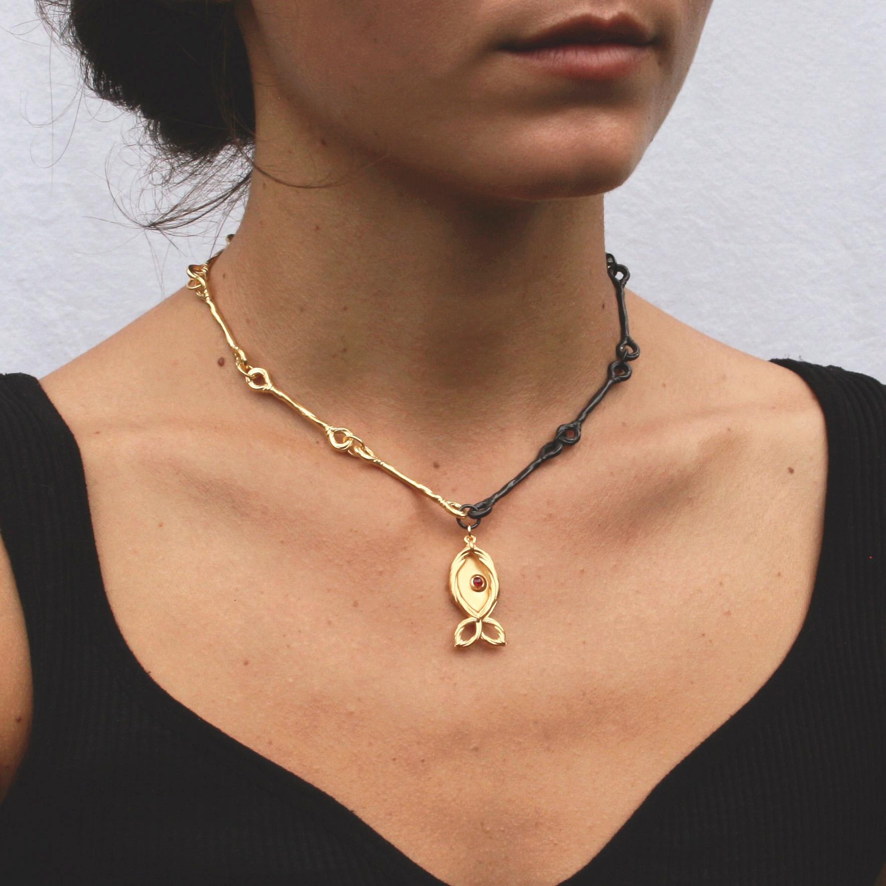 Our Two Tone Fish Choker is a striking embodiment of unity and togetherness. With one side plated in radiant gold and the other adorned with oxidized silver, it gracefully bridges the divide between contrasting elements. The centerpiece is a fish