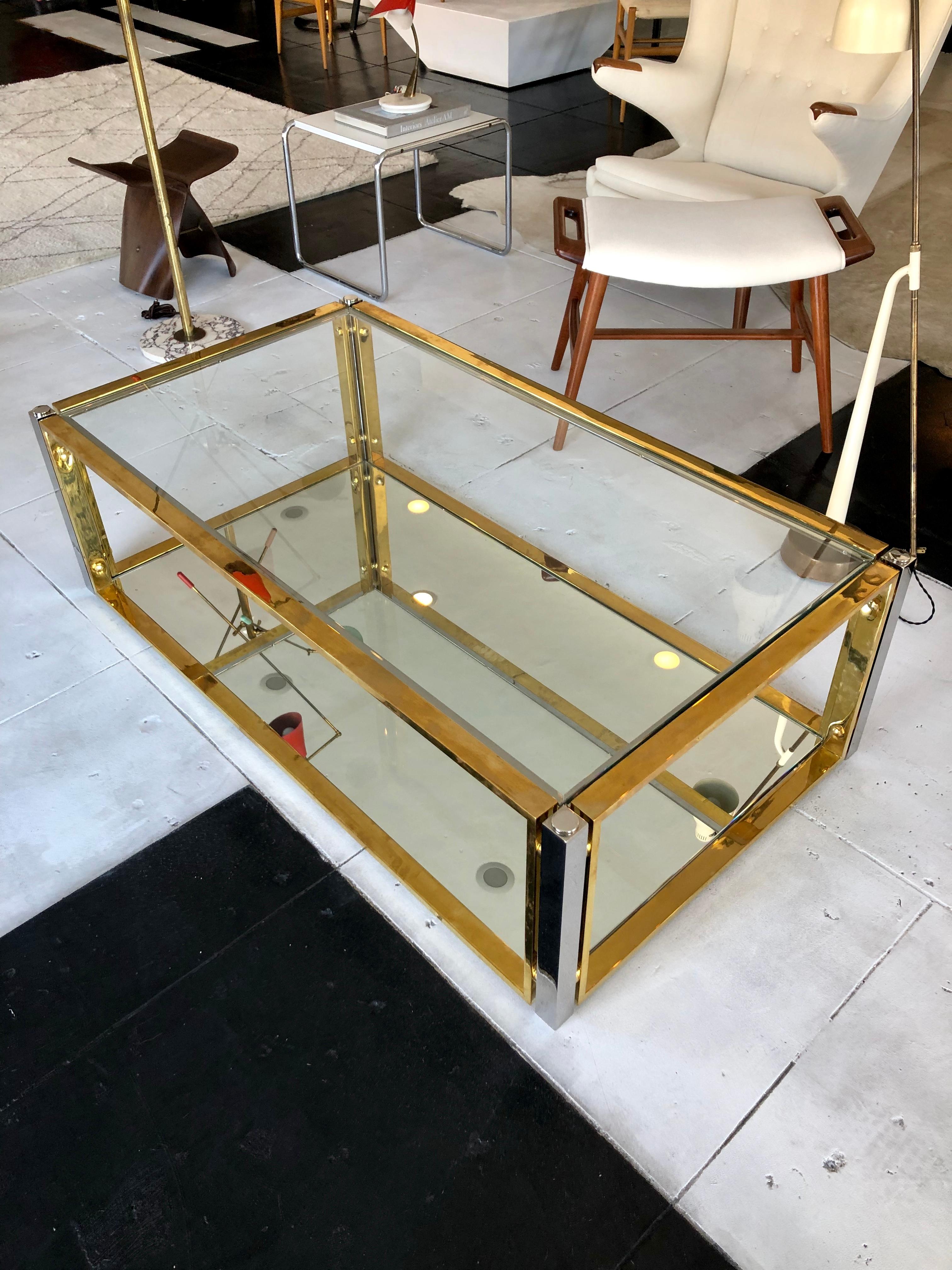 Most elegant two-tone French coffee table, 1960s. Brass and chrome with glass top and mirror on bottom shelf.