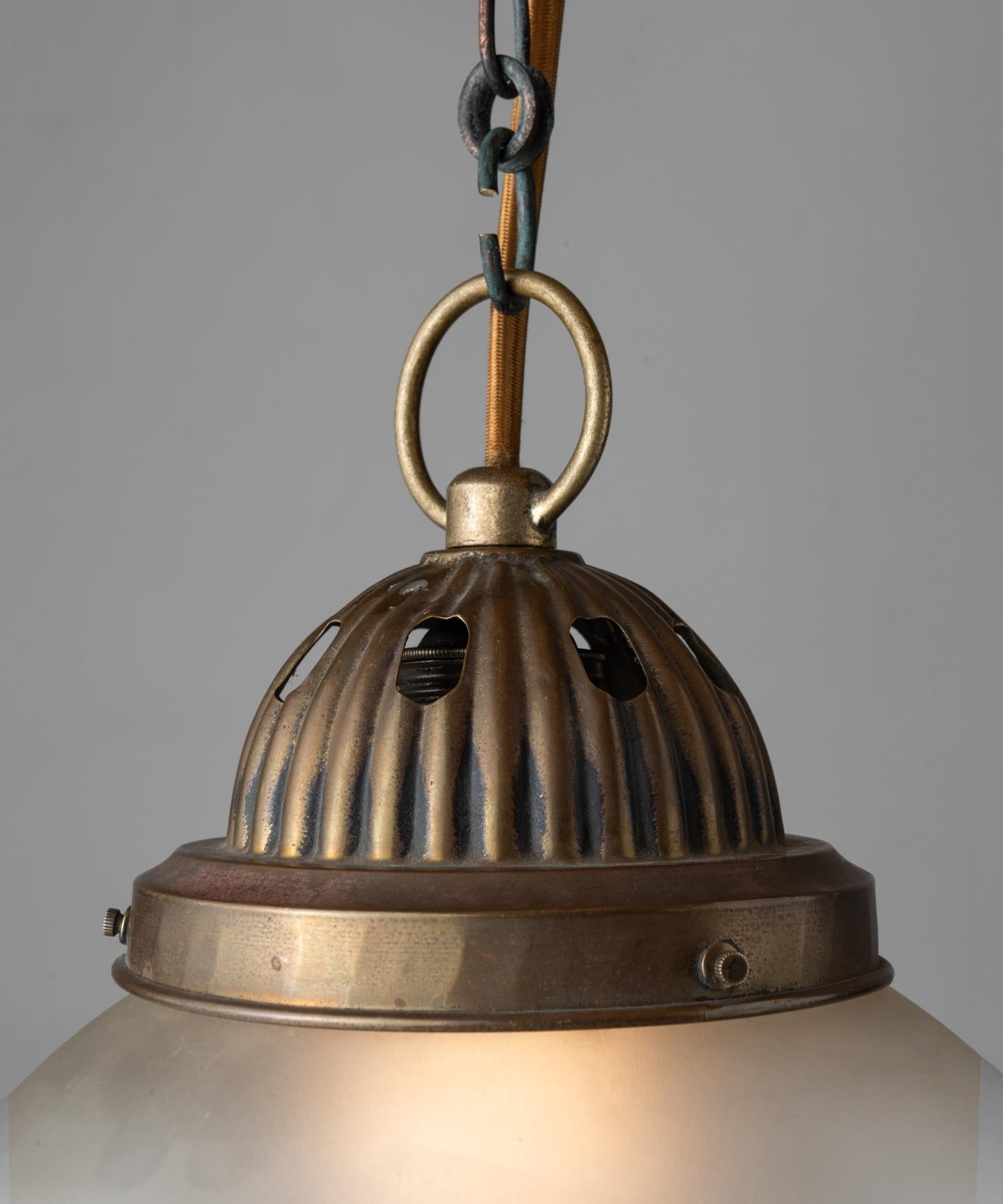 Unique pendant with etched glass globe with perforated clear glass bottom.

Measures: 9” diameter x 15” height (fixture).