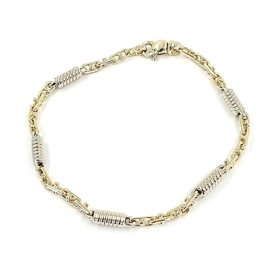 14 Karat White and Yellow Gold Men's Two Tone Bracelet Featuring A Coil and Anchor Link Design. 8.5 Inches Long with Lobster Clasp. Finished Weight Is 15.5 Grams.