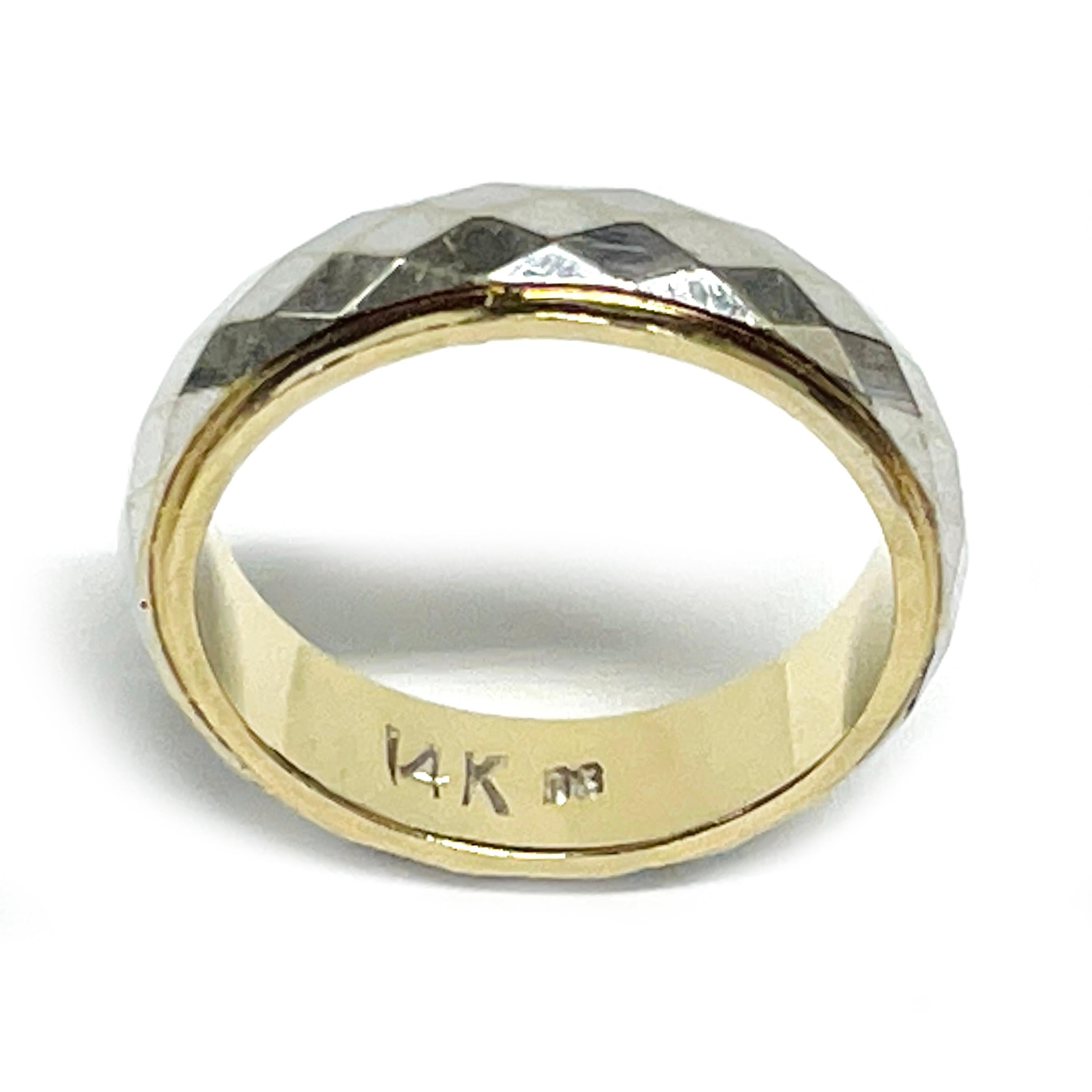 14 Karat White and Yellow Two-Tone Gold Diamond Cut Band. The ring features white gold in the center with diamond cut detail and a yellow gold base and trim with a smooth shiny finish. Stamped on the inside of the 4.67mm wide band is 14K 06. The