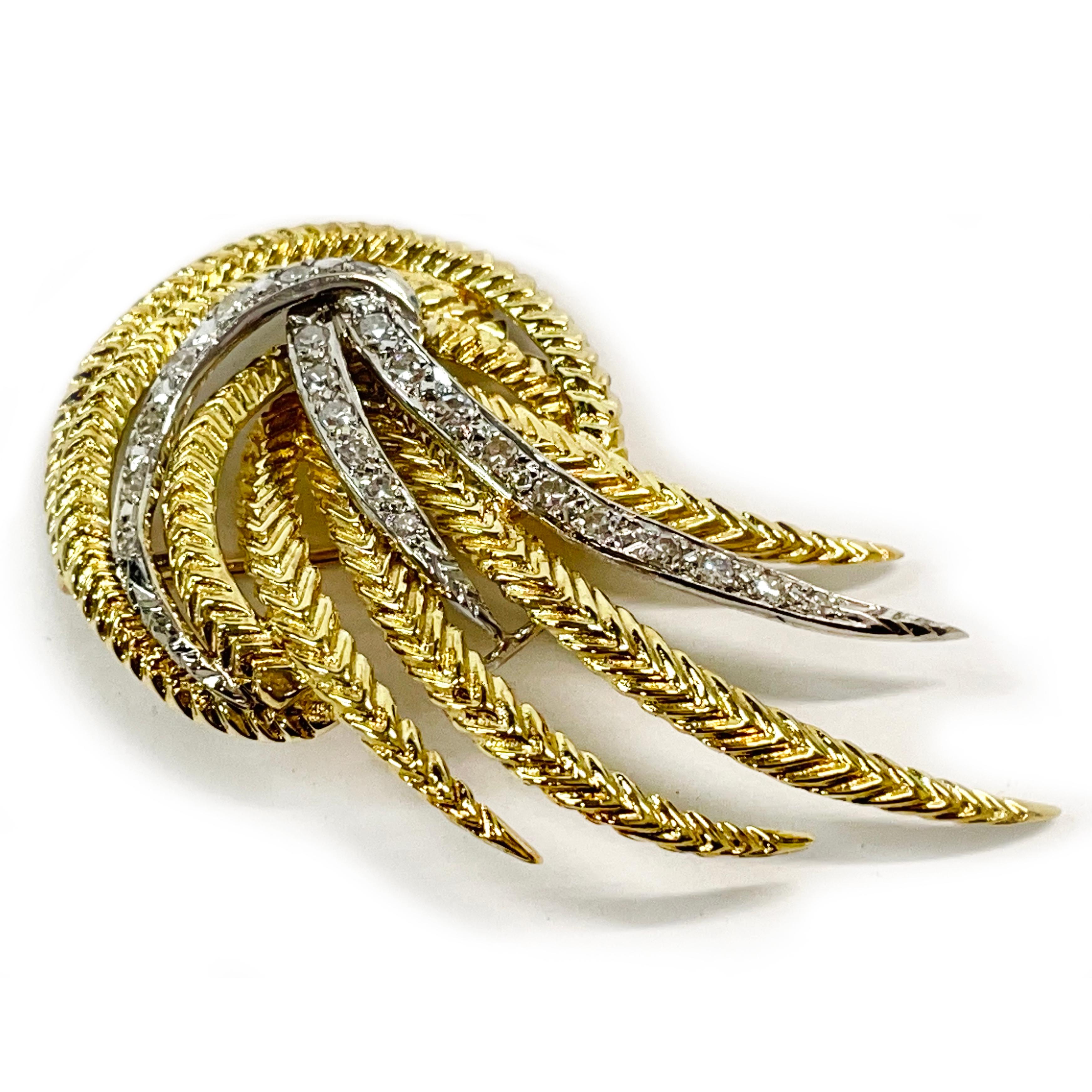 18 Karat Two Tone Gold Diamond Spray Brooch. This lovely brooch features twenty-four round diamonds set in white gold with textured swirls of yellow gold. The yellow gold tapered swirls have chevron shaped ridges. The diamonds measure 1.8mm and have