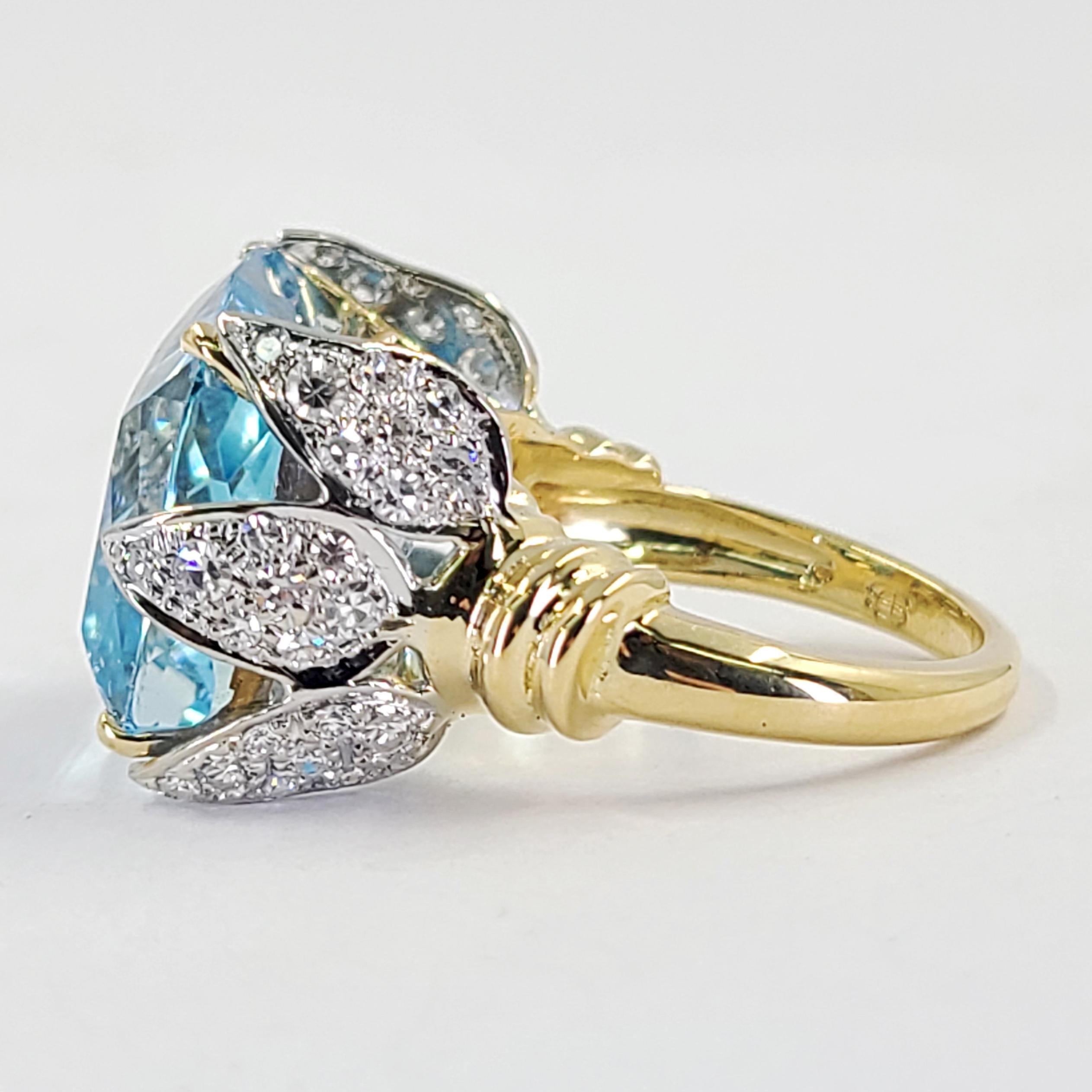 18 Karat Yellow & White Gold Ring Featuring An 18 Carat Cushion Cut Aquamarine Set Horizontally With 3 Pave Petals or Leaves On Each Side. 48 Single Cut Diamonds Of VS Clarity & G Color Total An Additional 1.00 Carat. Finger Size 6.75; Purchase