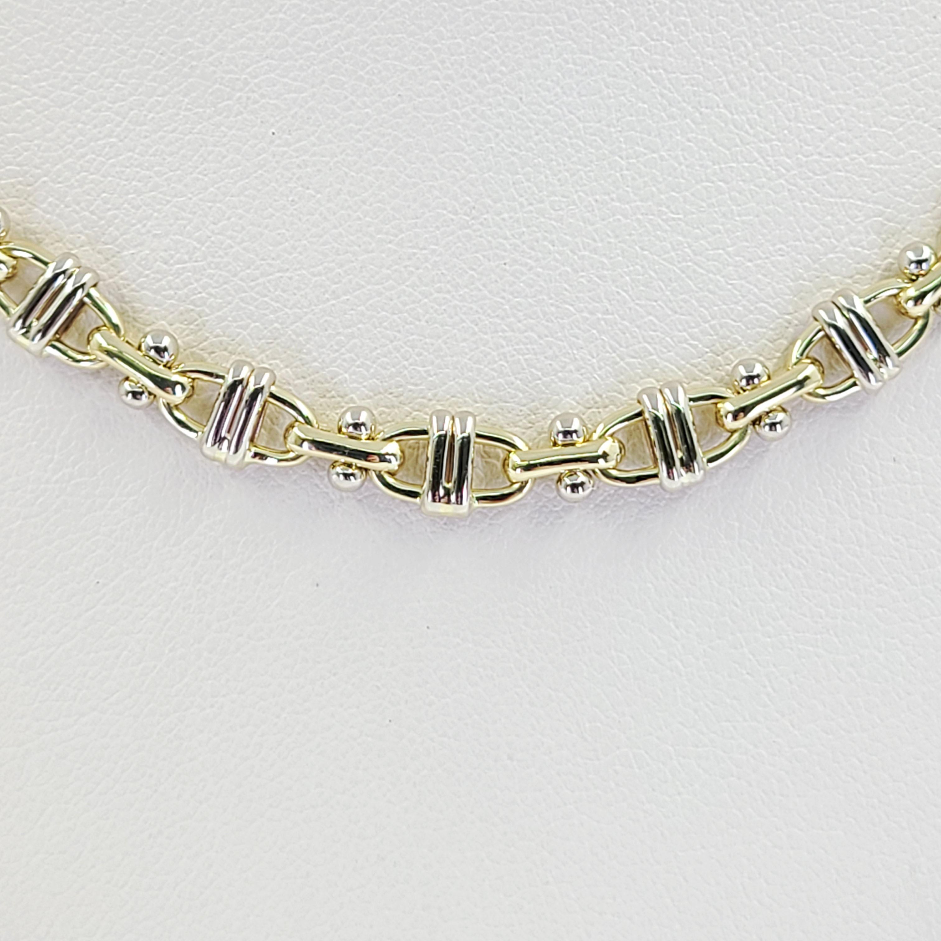 18 Karat White and Yellow Gold Anchor Link Chain Measuring 24 Inches Long With Large Lobster Clasp. Finished Weight Is 39.0 Grams.