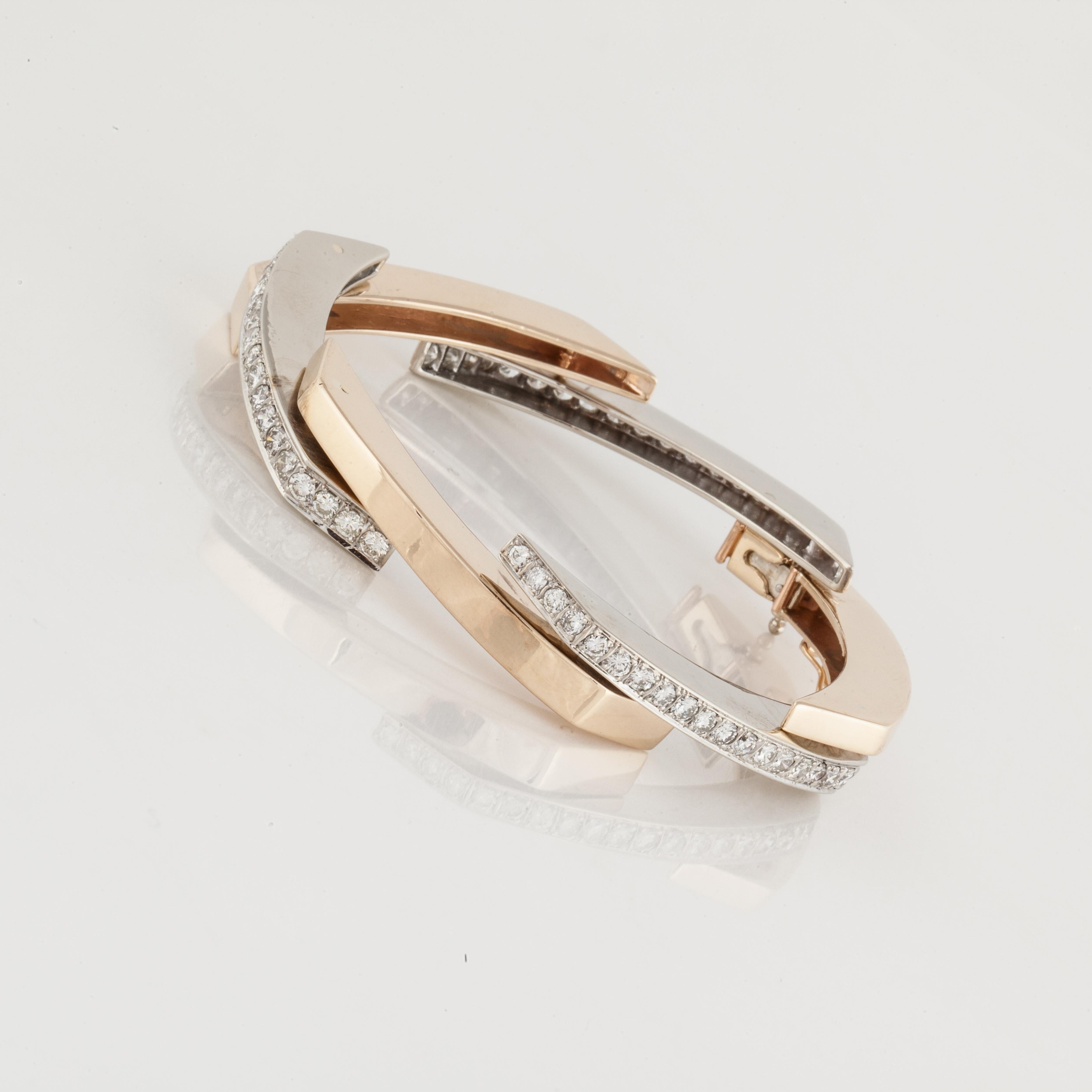 14K gold bracelet in a modernistic design featuring alternating white gold and yellow gold elongated links with diamonds set into the white gold links.  There are 66 round diamonds totaling 4.80 carats; H-I color and VS clarity.  Bracelet measures 7