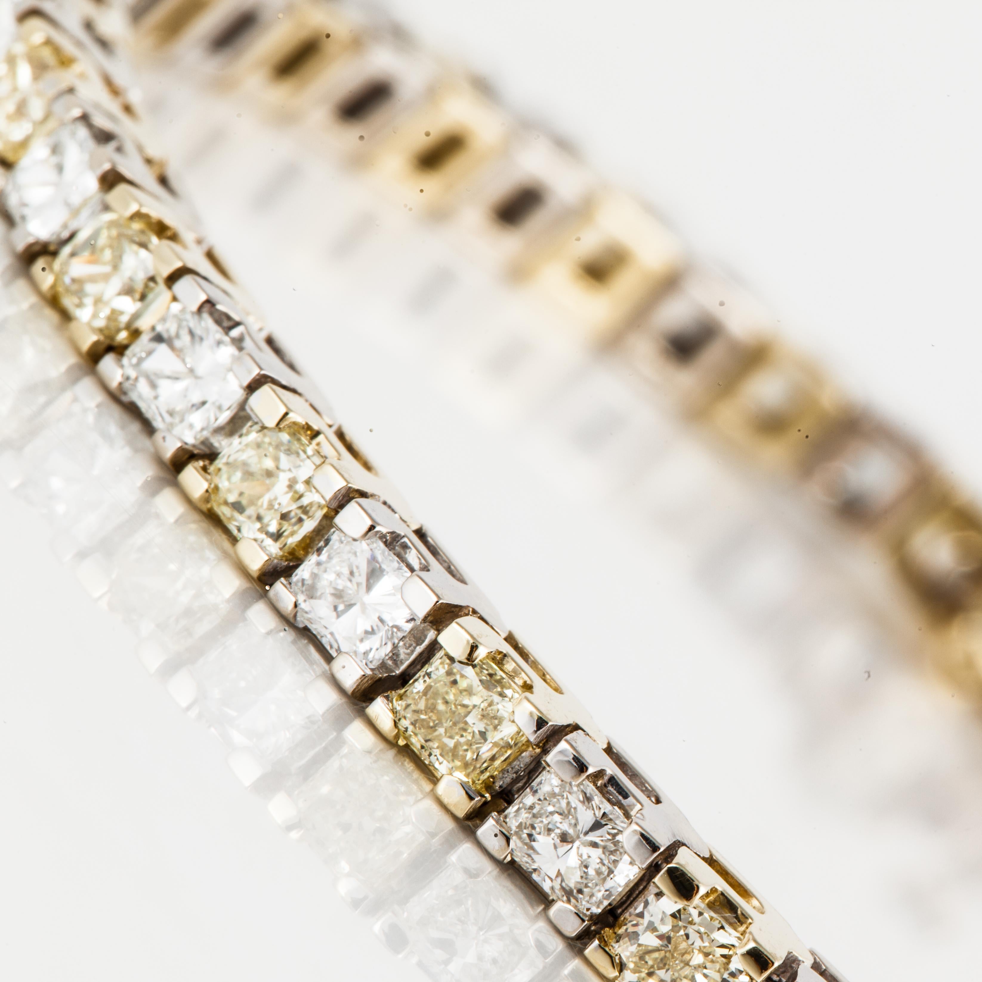 18K two-tone gold straightline bracelet with yellow and white diamonds.  There are 26 cushion-cut yellow diamonds, set in yellow gold, that total 5.75 carats;  fancy intense yellow color and VS-SI clarity.  Also, there are 24 radiant-cut diamonds