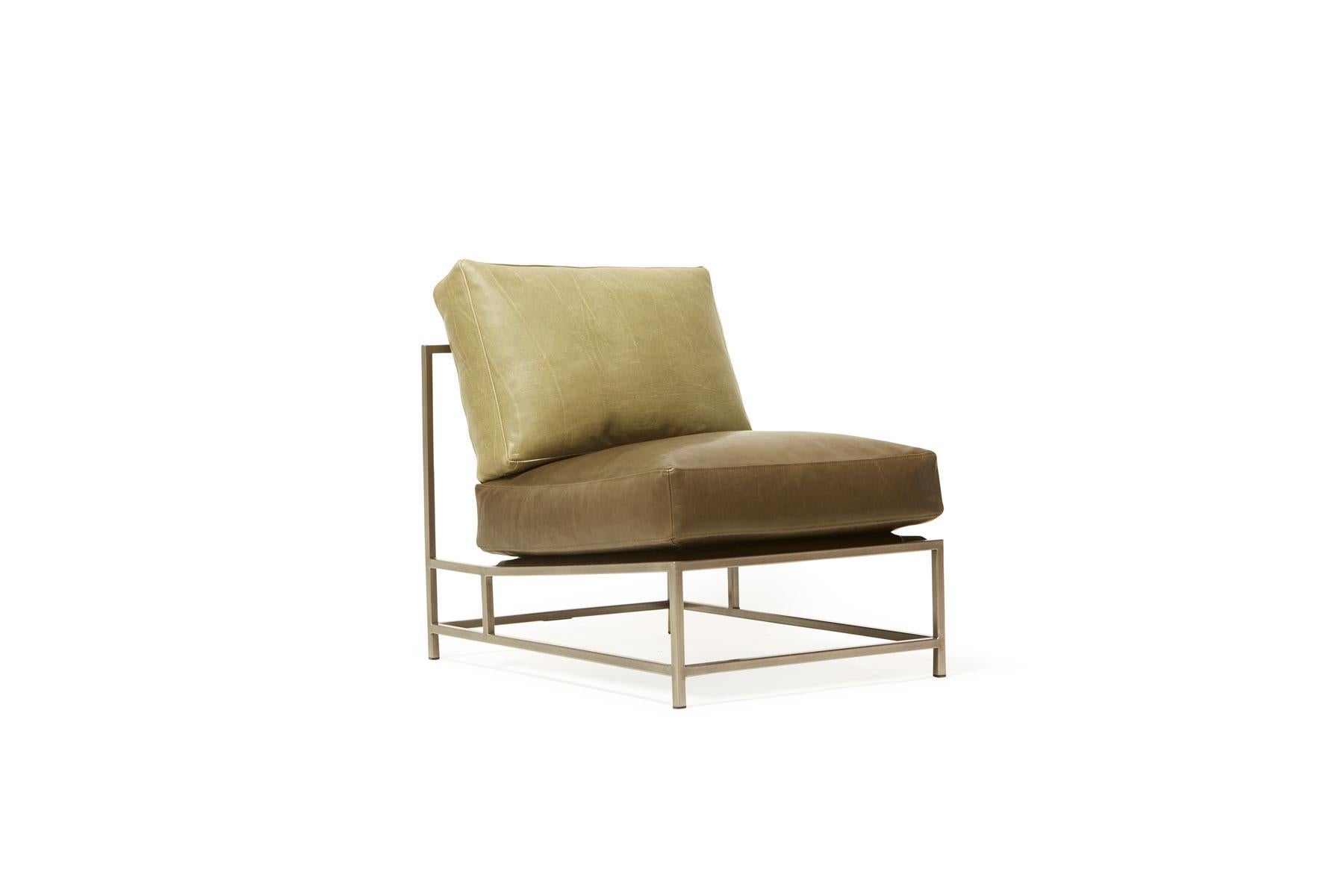Sleek and refined, the Inheritance chair is a great addition to nearly any space. 

This variation is upholstered in two-tone green leather. The foam seat cushions have been wrapped in down, allowing for a soft and comfortable lounge experience.