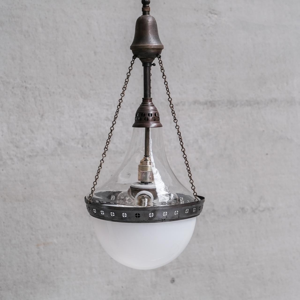 A large two tone pendant lamp. 

France, c1910. 

Exceptional form, with unusual details, from the plafonnier style chains to the coffee bean style decoration around the rim. 

The two styles of glass is a pleasing contrast. 

Naturally patinated.