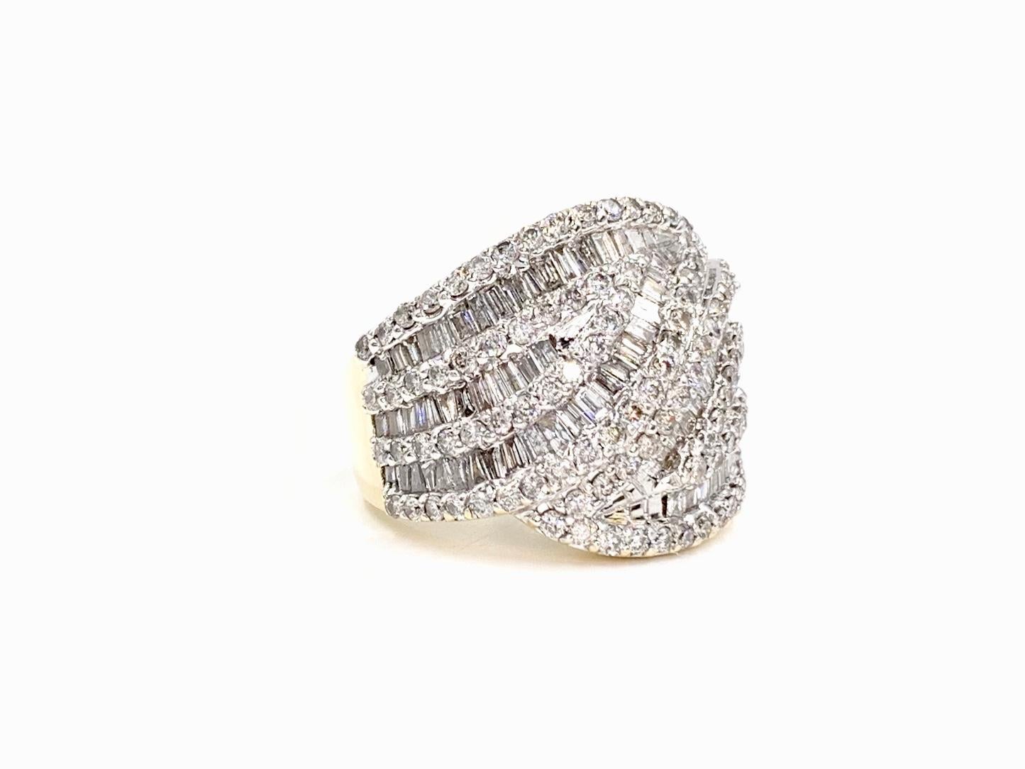 Two sparkling large diamond leafs connect in a bypass-illusion design wide 14 karat gold ring featuring approximately 3 carats of baguette and round brilliant diamonds. Diamond quality is approximately H color, I1 clarity. Diamonds are set with