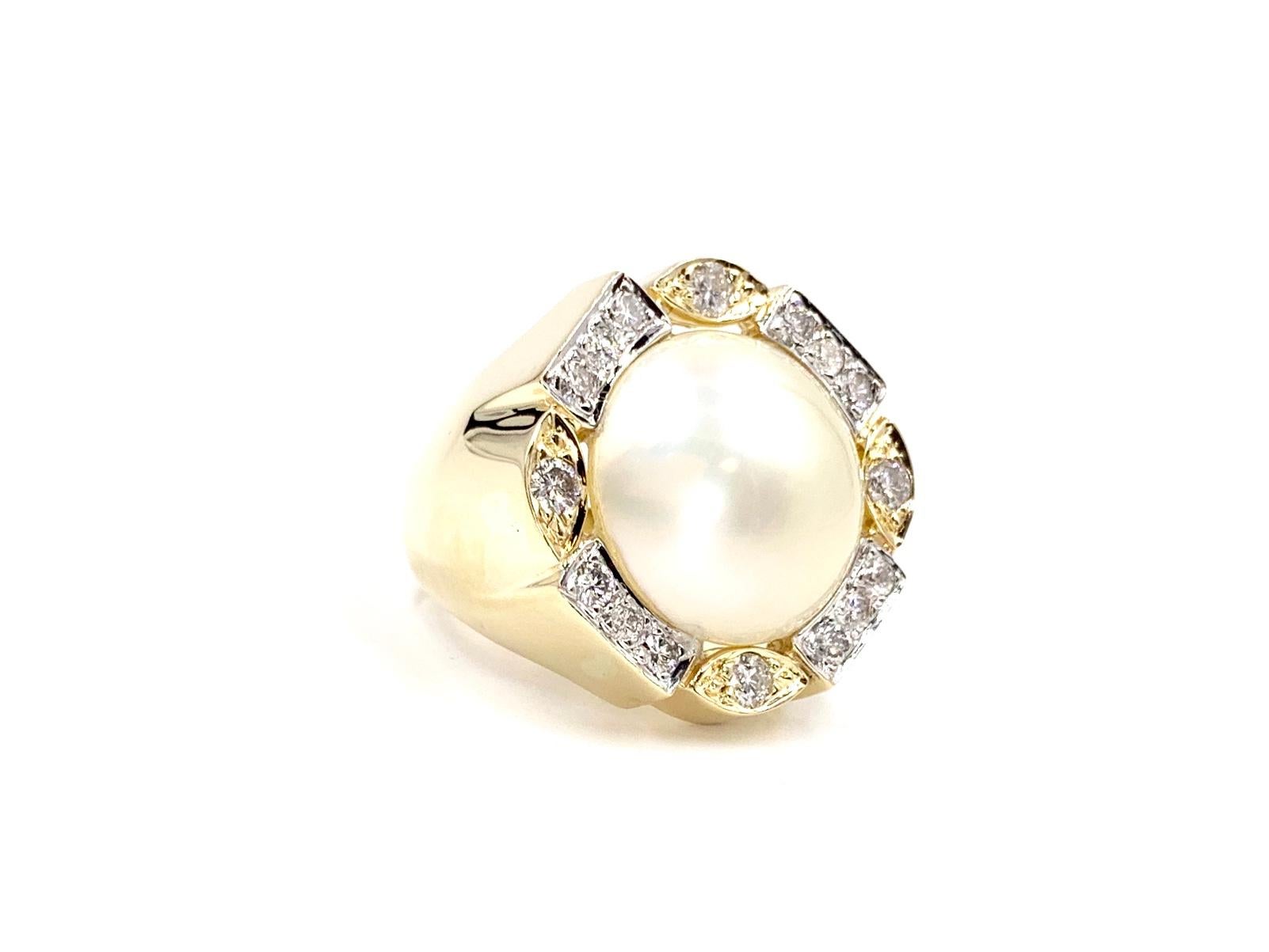 A well made, heavy 14 karat yellow and white gold mabe pearl ring featuring .80 carats of white round brilliant diamond. Diamond quality is approximately G color, SI2 clarity. 11.5mm Pearl is smooth and lustrous. Ring is a larger statement piece yet