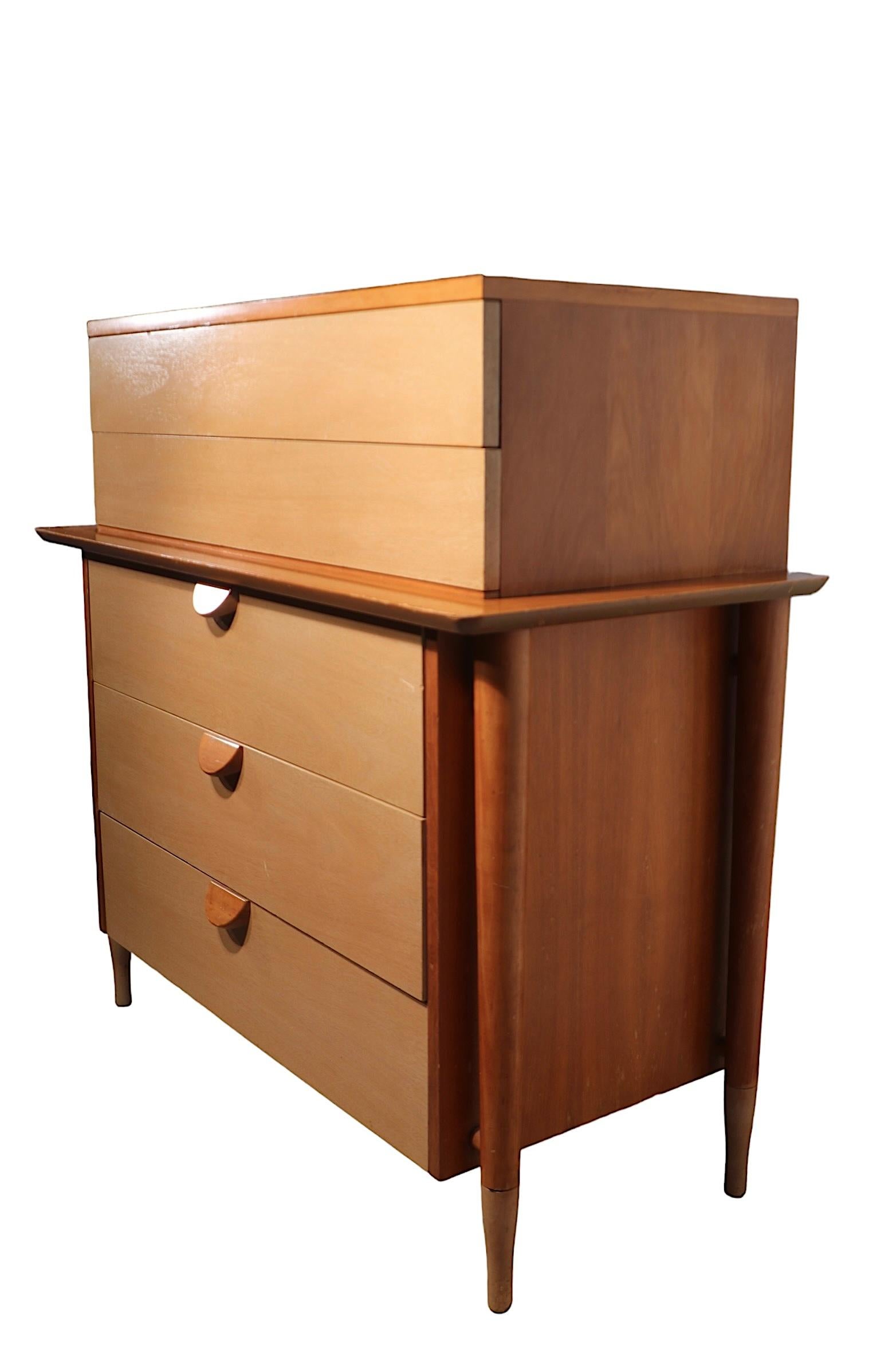 Exceptional  Mid Century Highboy, Chest on Chest, dresser made by noted American maker Basic Witz. The dresser features a two drawer top section, under which  are three larger drawers. The cabinet has an exposed frame with a beveled overhang shelf