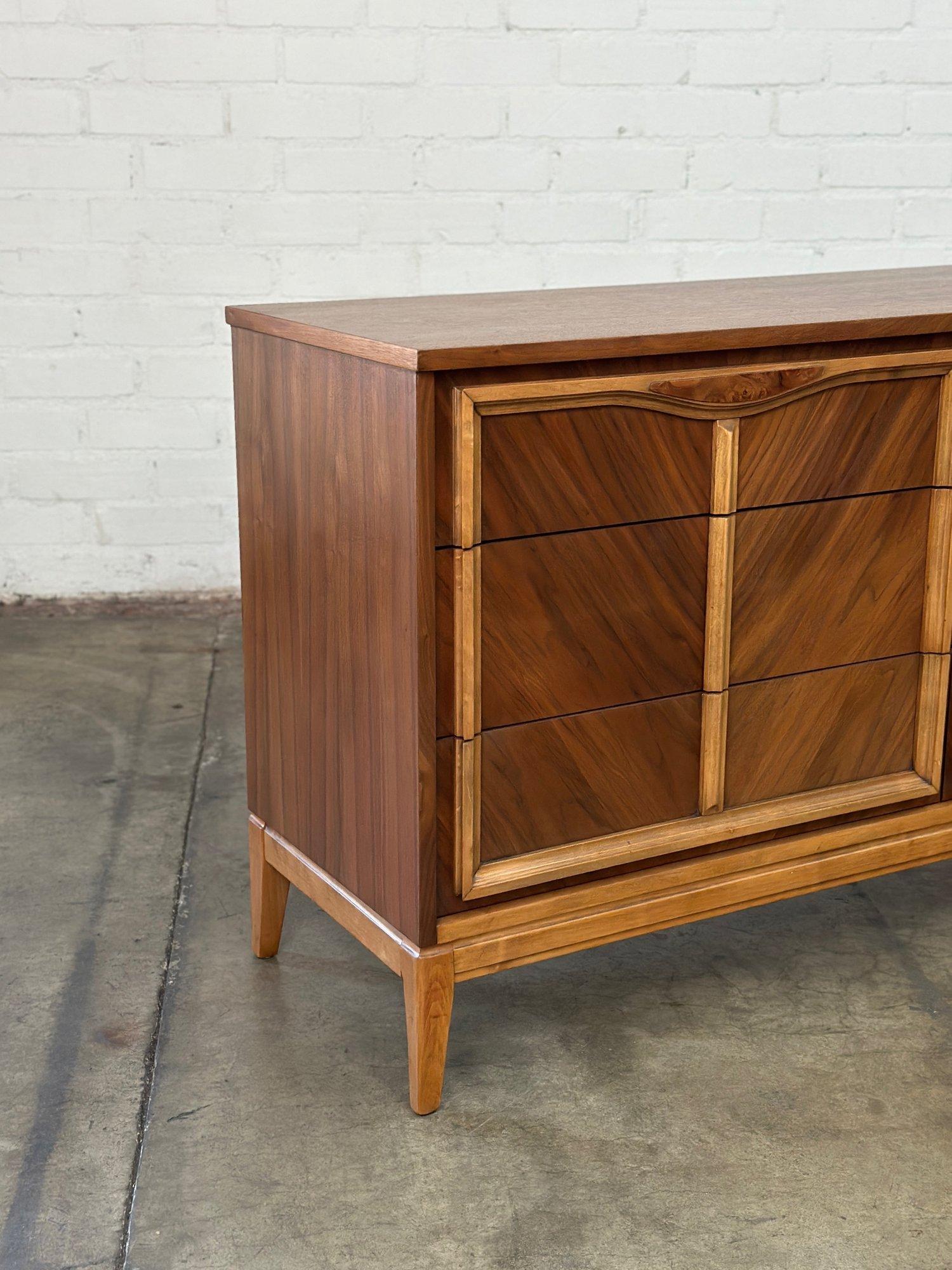 W56.5 D18.5 H31.25

Fully restored mid century dresser in great condition. Item features sculpted trim and small burlwood inlay on the top of drawers. Dresser is structurally sound and fully functional. 